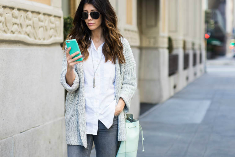 White top, grey jeans, mint bag