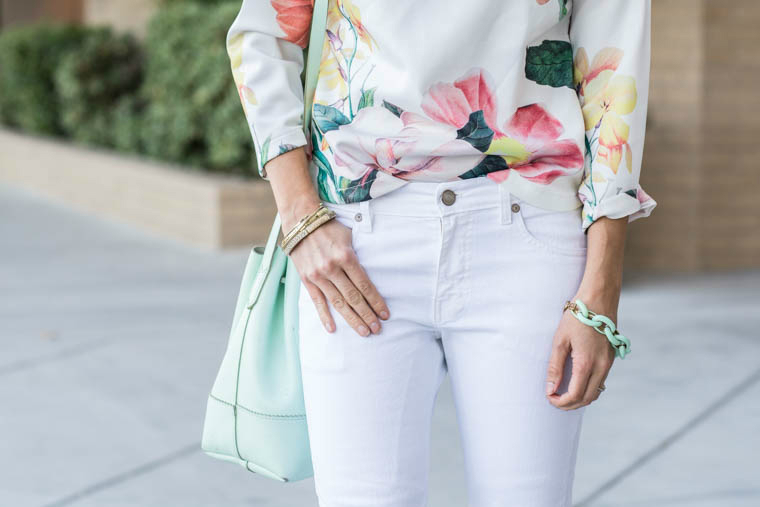 White jeans, floral top, mint bucket bag