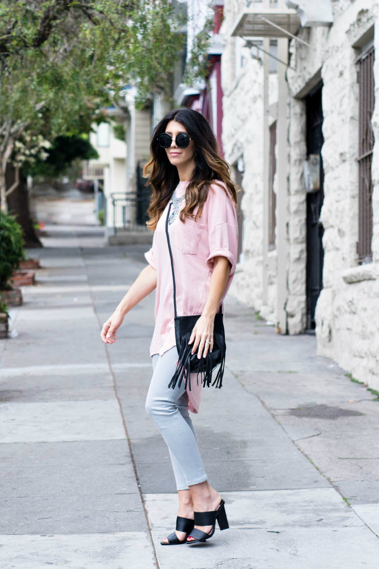 round sunnies, pink top, grey jeans, fringe bag