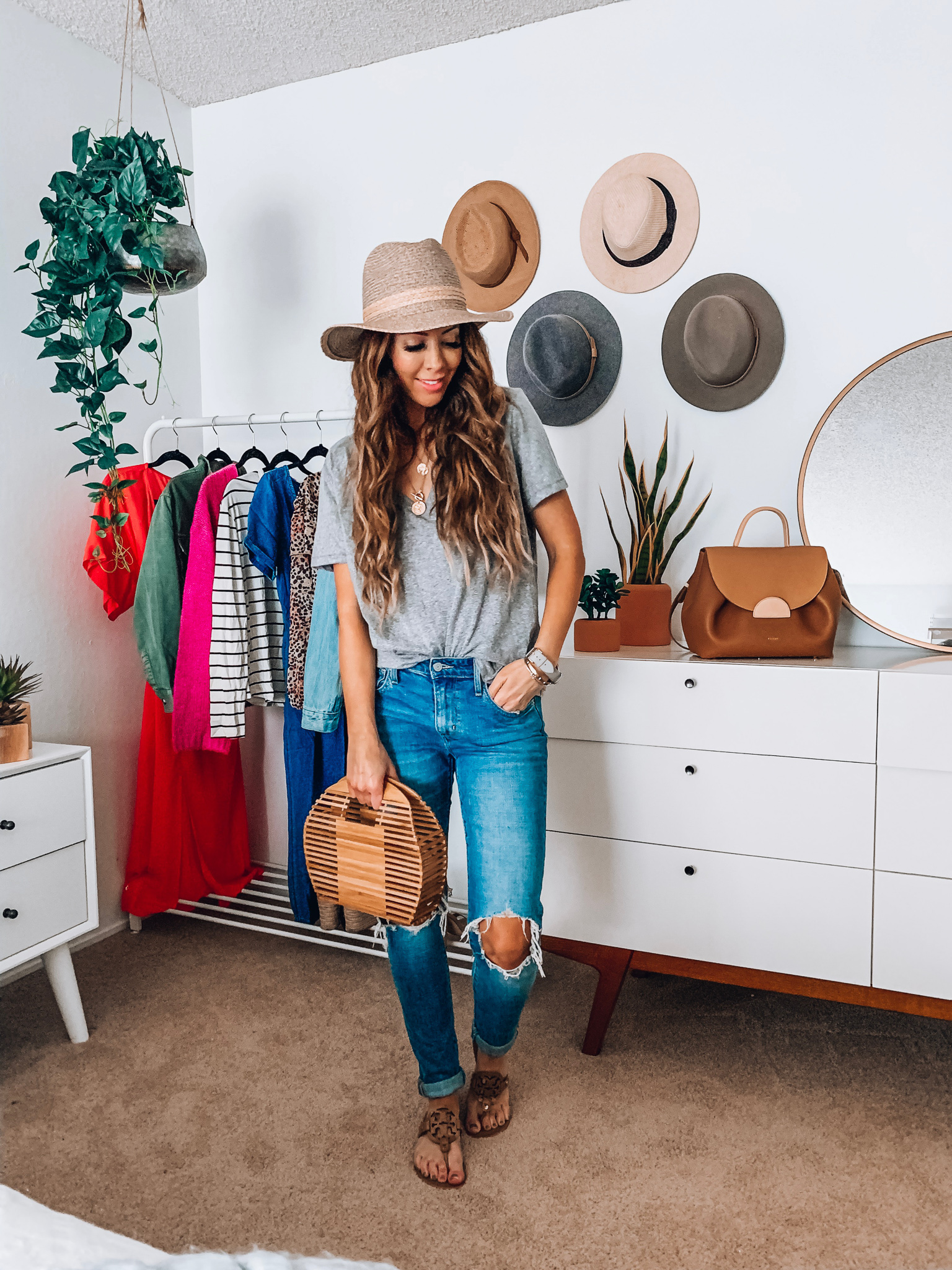 ShopBop Sale featured by top US fashion blog The Girl in the Yellow Dress; Image of a woman wearing Levi jeans, Zaya shirt, Tory Burch sandals and Shopbop hat.