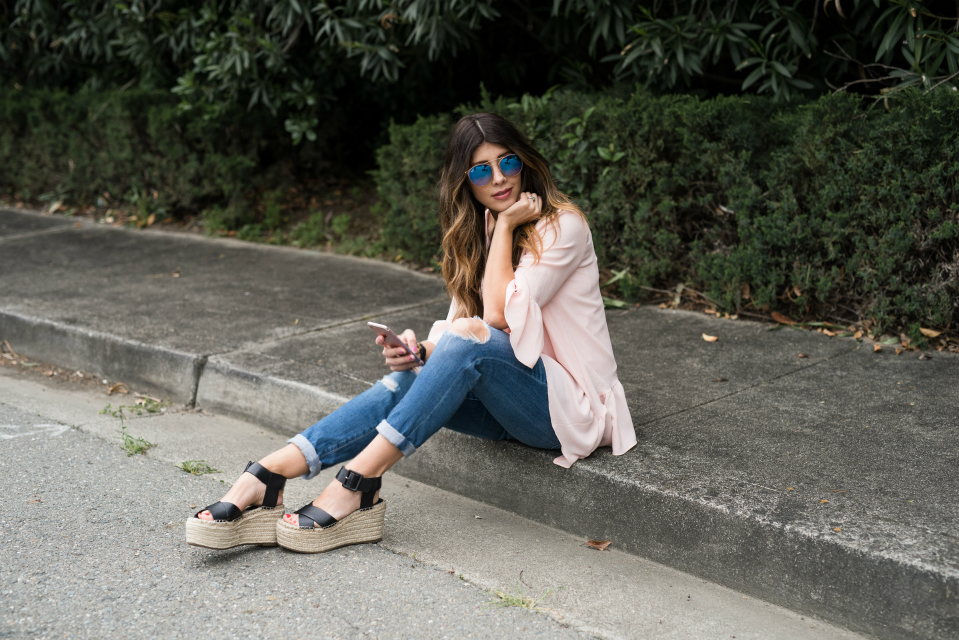 Spring Shoe Trends featured by top US fashion blog The Girl in the Yellow Dress; Image of a woman wearing Gibson ruffle top, AG jeans, Marc Fisher wedges, Cluse watch and Ray-Ban sunglasses.