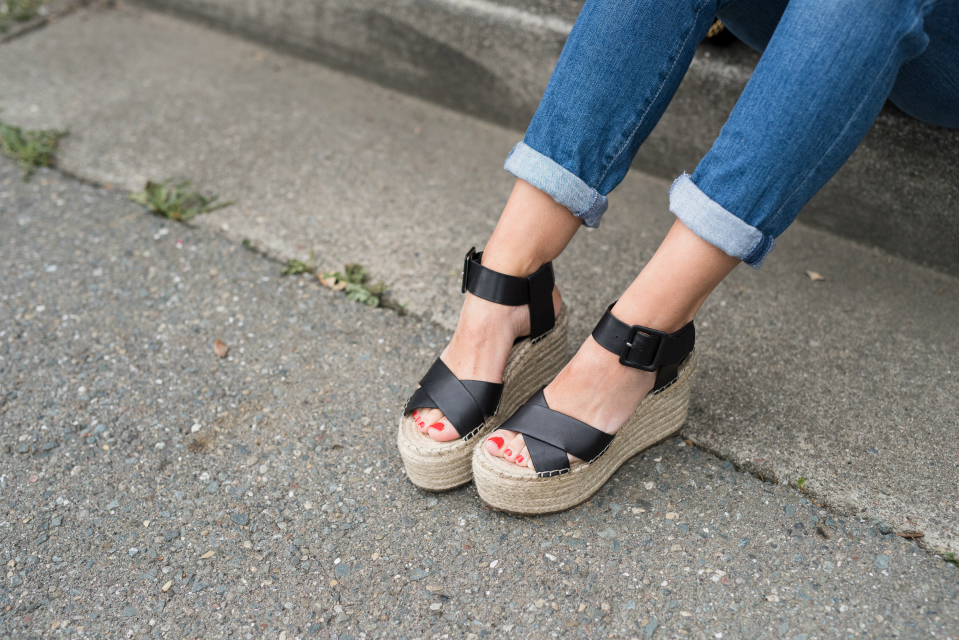 Spring Shoe Trends featured by top US fashion blog The Girl in the Yellow Dress; Image of a woman wearing Gibson ruffle top, AG jeans, Marc Fisher wedges, Cluse watch and Ray-Ban sunglasses.