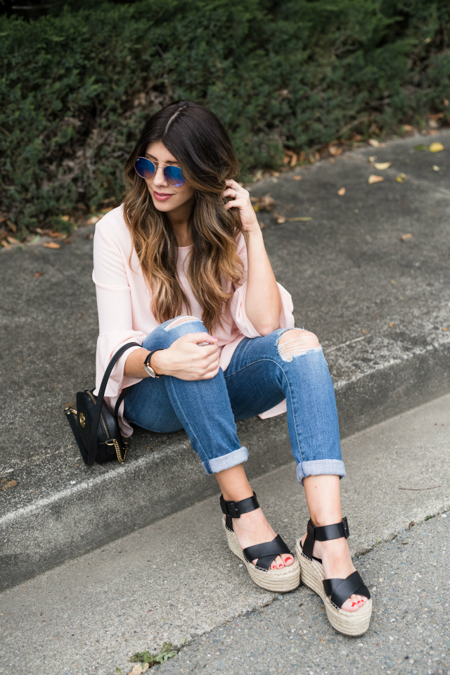 Spring Shoe Trends featured by top US fashion blog The Girl in the Yellow Dress; Image of a woman wearing Gibson ruffle top, AG jeans, Marc Fisher wedges, Cluse watch and Ray-Ban sunglasses.