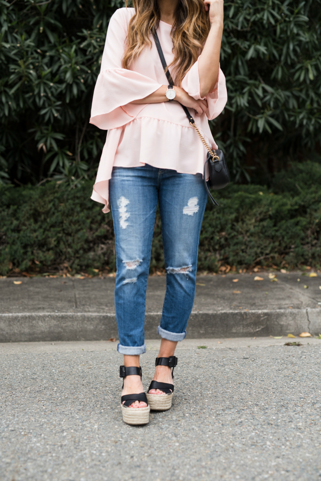 Spring Shoe Trends featured by top US fashion blog The Girl in the Yellow Dress; Image of a woman wearing Gibson ruffle top, AG jeans, Marc Fisher wedges, Cluse watch and Ray-Ban sunglasses.