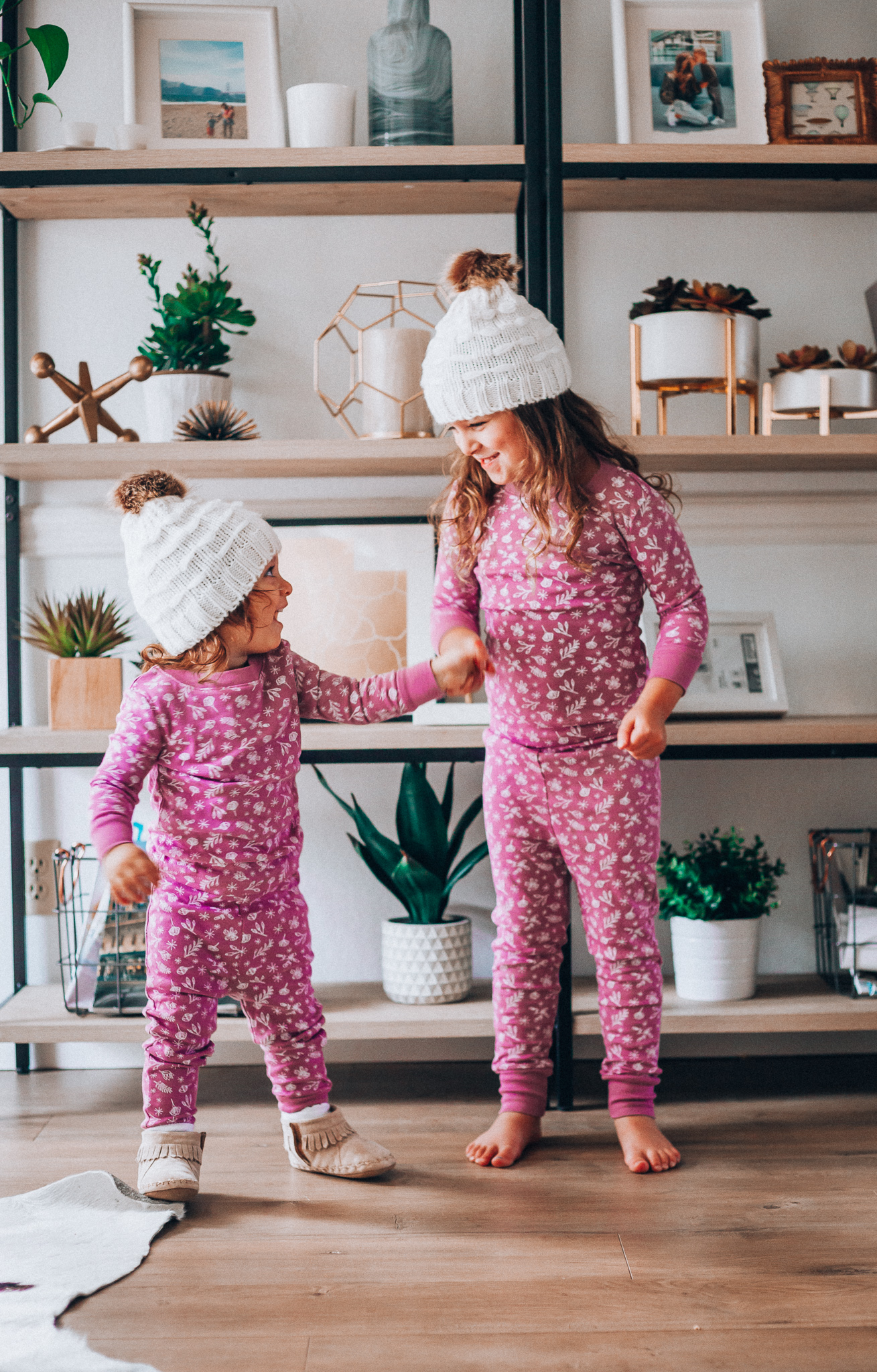 The Best Family Christmas Pajamas by popular San Francisco life and style blog, The Girl in the Yellow Dress: image of two kids wearing Old Navy Graphic Pajama Set for Girls, and H&M Knit Hat with Pompom.