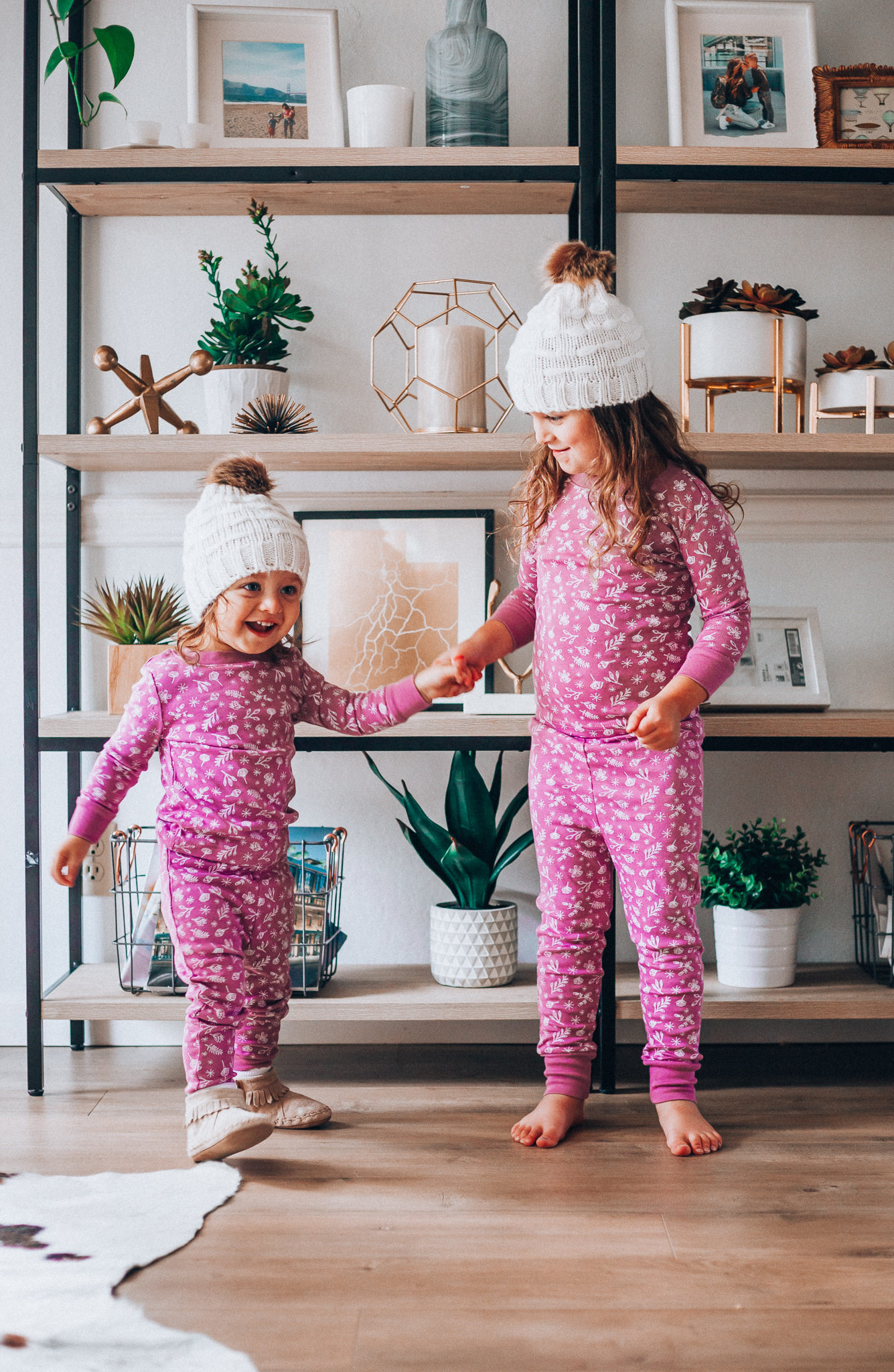 The Best Family Christmas Pajamas by popular San Francisco life and style blog, The Girl in the Yellow Dress: image of two kids wearing Old Navy Graphic Pajama Set for Girls, and H&M Knit Hat with Pompom.