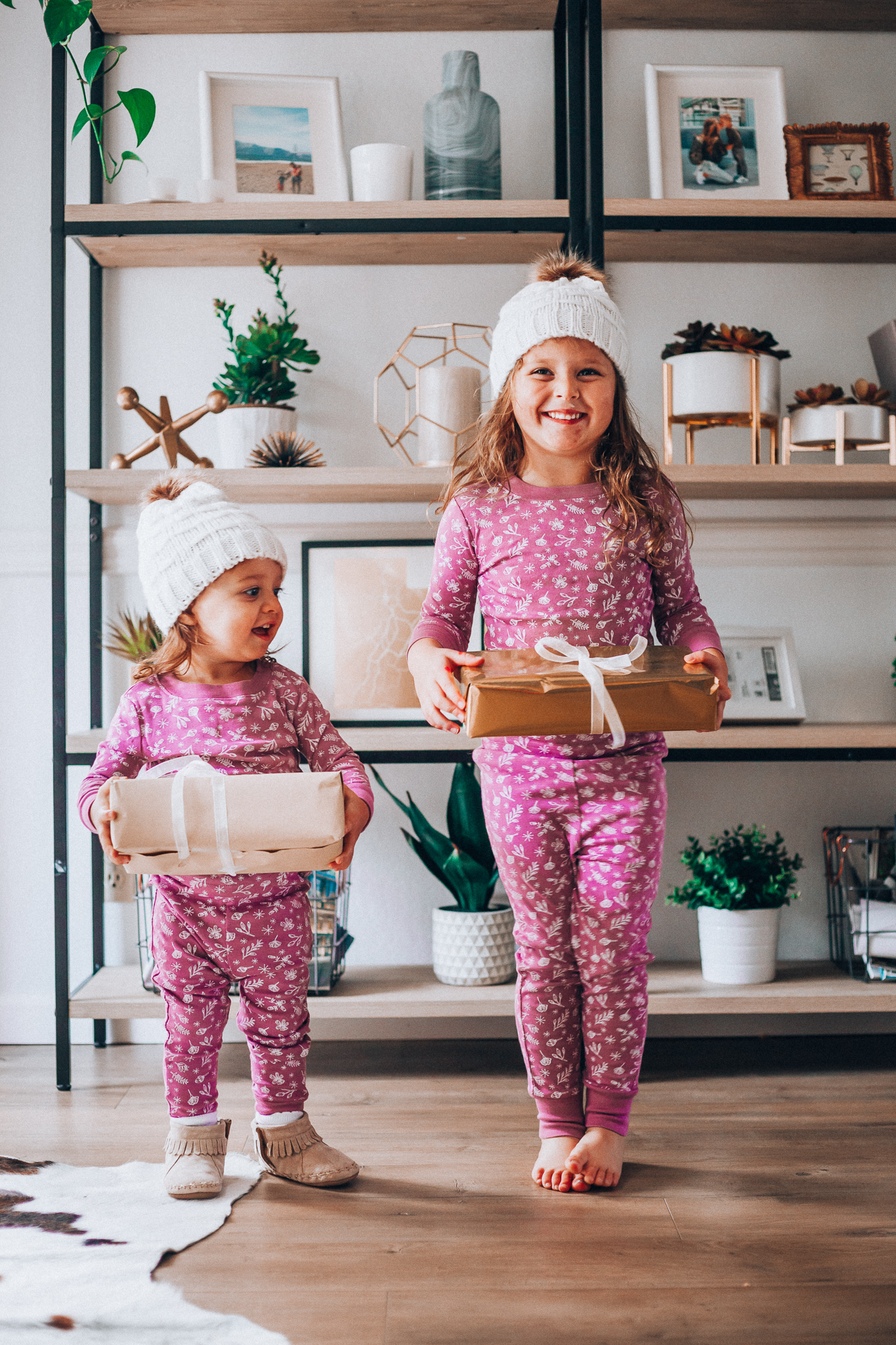 The Best Family Christmas Pajamas by popular San Francisco life and style blog, The Girl in the Yellow Dress: image of two kids wearing Old Navy Graphic Pajama Set for Girls, and H&M Knit Hat with Pompom.