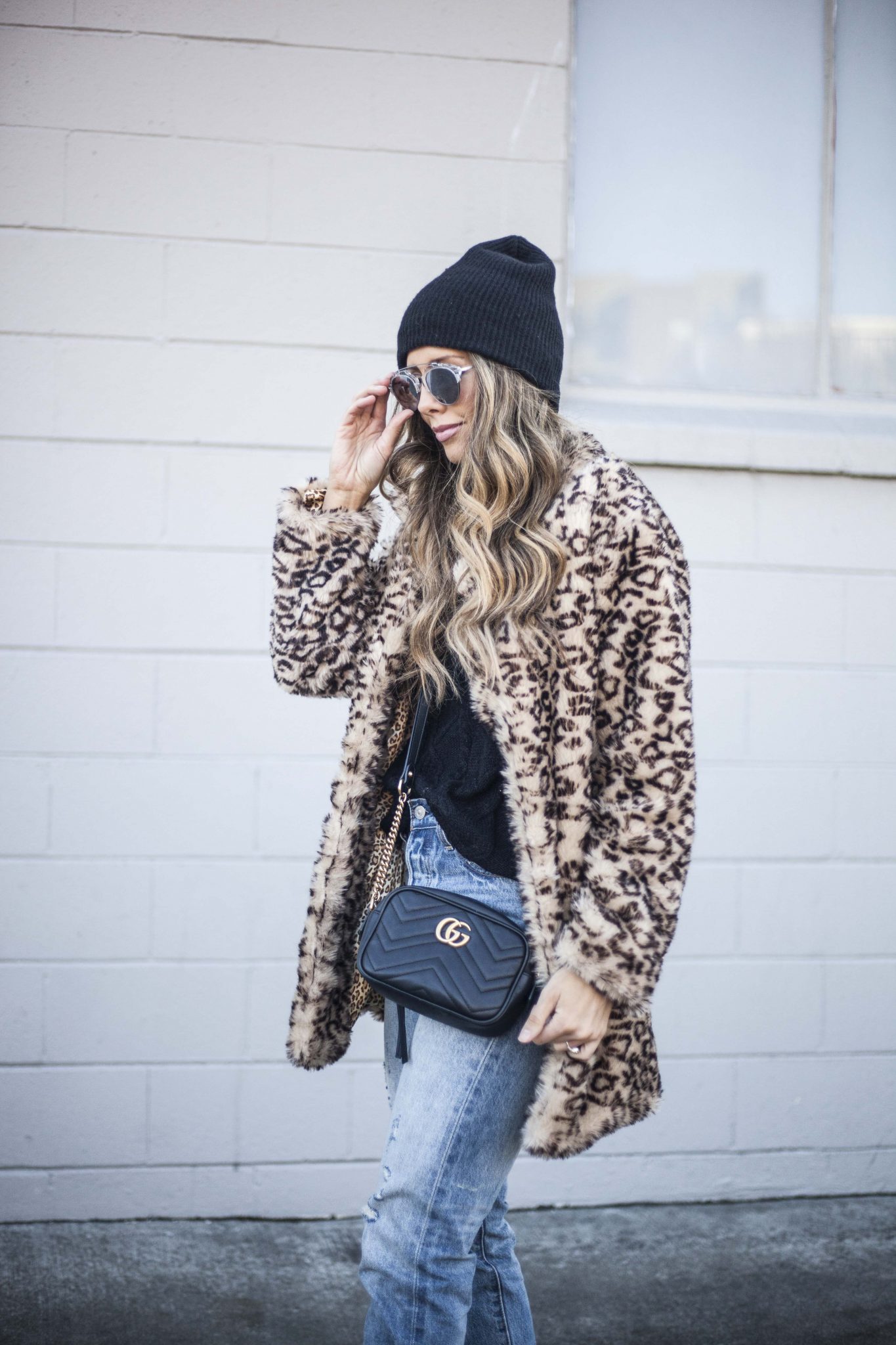 Leopard Faux Fur Coat, Levi Mom Jeans, Black Beanie, Black Cable Knit Sweater, Gucci Handbag, Mvmt Sunglasses