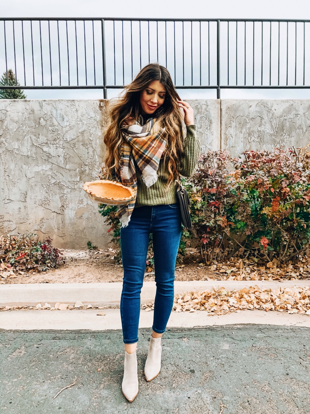 The BEST Black Friday and Cyber Monday Sales featured by top San Francisco life and style blog, The Girl in the Yellow Dress: picture of a woman wearing tan booties, plaid scarf, denim skinny jeans and green cozy sweater