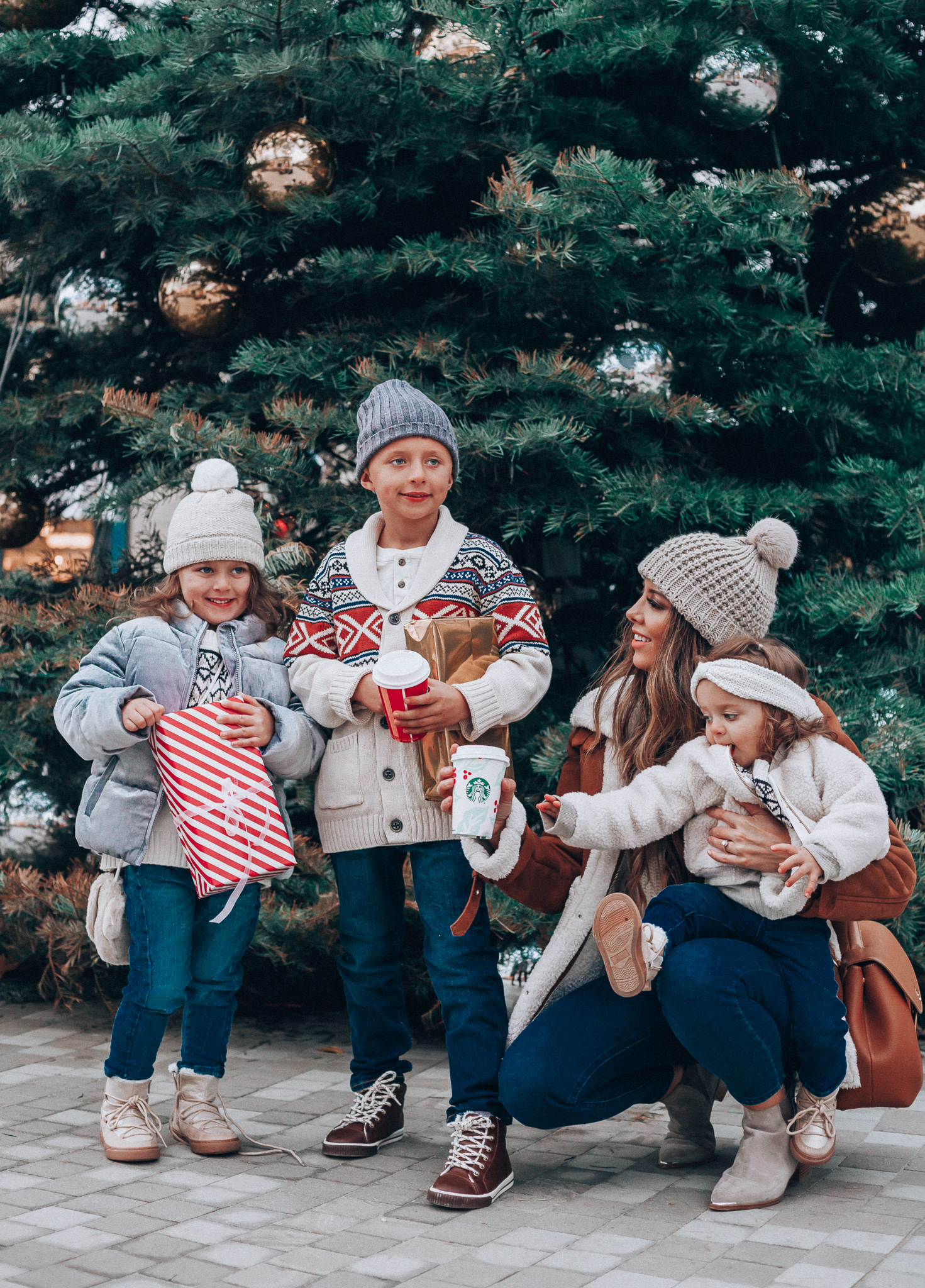 Gymboree Holiday Collection featured by top San Francisco fashion blog, The Girl in the Yellow Dress: image of a mom wearing a Abercrombie & Fitch mock neck sweater, high waist ankle jeans, Mark Fisher Chelsea boots, a pom pom beanie and a leather shoulder bag. A toddler wearing a Gymboree headband, sherpa jacket, sweater, jeggings and metallic moon boots. A boy wearing a Gymboree beanie, sweater, jeans and leather high tops. A girl wearing a Gymboree beanie, coat, sweater, jeans and boots