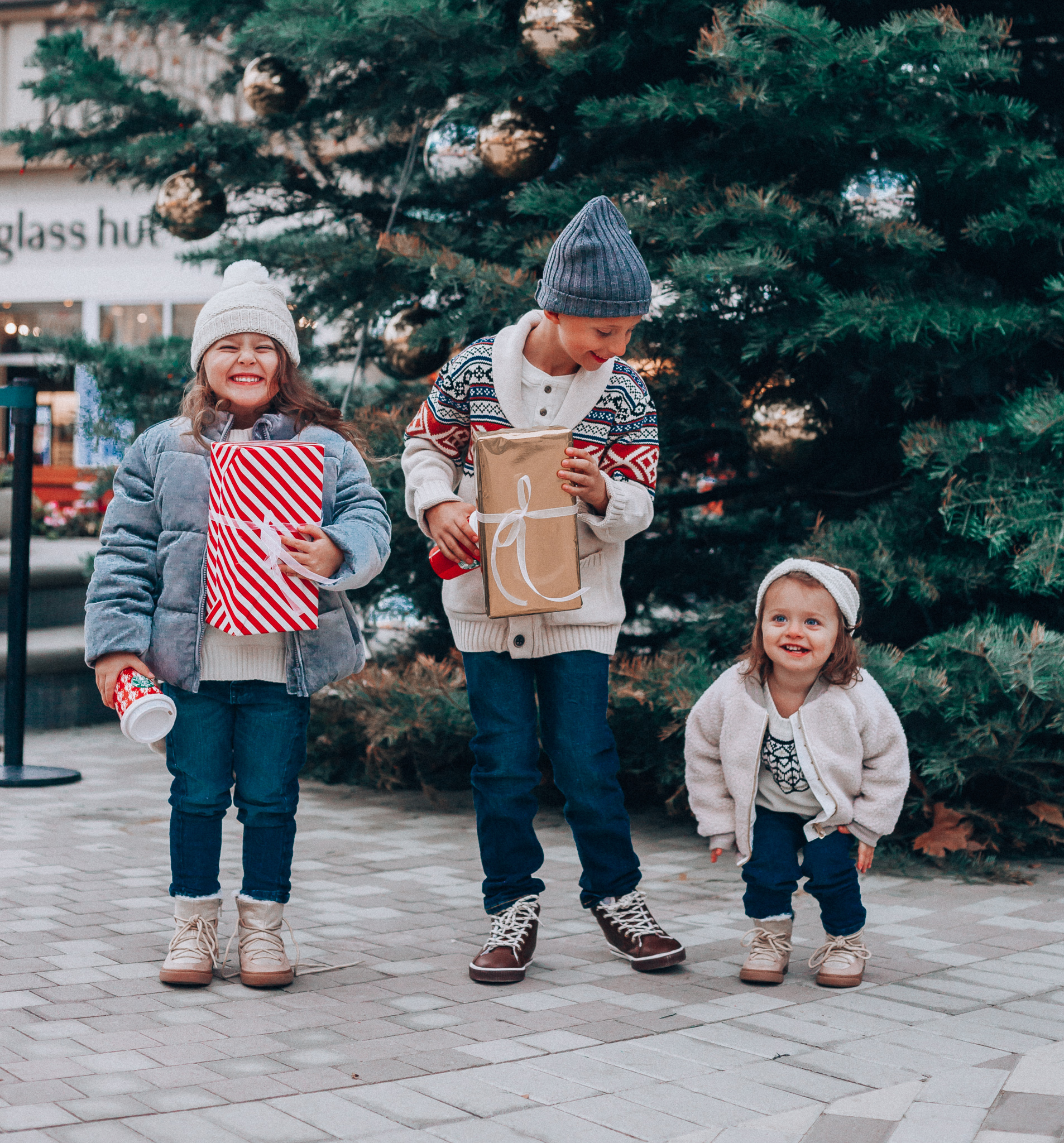 Gymboree Holiday Collection featured by top San Francisco fashion blog, The Girl in the Yellow Dress: image of a mom wearing a Abercrombie & Fitch mock neck sweater, high waist ankle jeans, Mark Fisher Chelsea boots, a pom pom beanie and a leather shoulder bag. A toddler wearing a Gymboree headband, sherpa jacket, sweater, jeggings and metallic moon boots. A boy wearing a Gymboree beanie, sweater, jeans and leather high tops. A girl wearing a Gymboree beanie, coat, sweater, jeans and boots