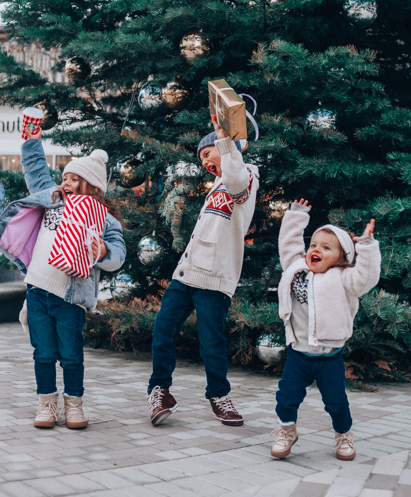 Gymboree Holiday Collection featured by top San Francisco fashion blog, The Girl in the Yellow Dress: image of a mom wearing a Abercrombie & Fitch mock neck sweater, high waist ankle jeans, Mark Fisher Chelsea boots, a pom pom beanie and a leather shoulder bag. A toddler wearing a Gymboree headband, sherpa jacket, sweater, jeggings and metallic moon boots. A boy wearing a Gymboree beanie, sweater, jeans and leather high tops. A girl wearing a Gymboree beanie, coat, sweater, jeans and boots