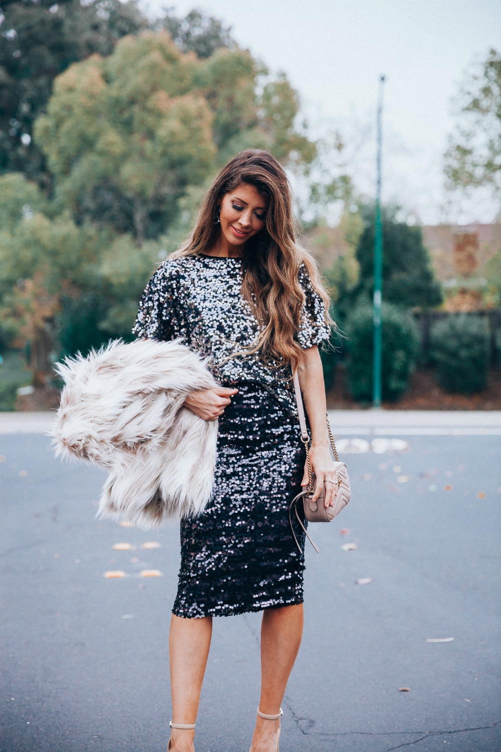 Cute NYE look featured by top San Francisco fashion blog, The Girl in the Yellow Dress: image of a woman wearing an H&M sequin skirt, H&M sequin top, Stella coat, Sam Edelman strap sandals, Gucci leather camera bag, Baublebar drop statement earrings