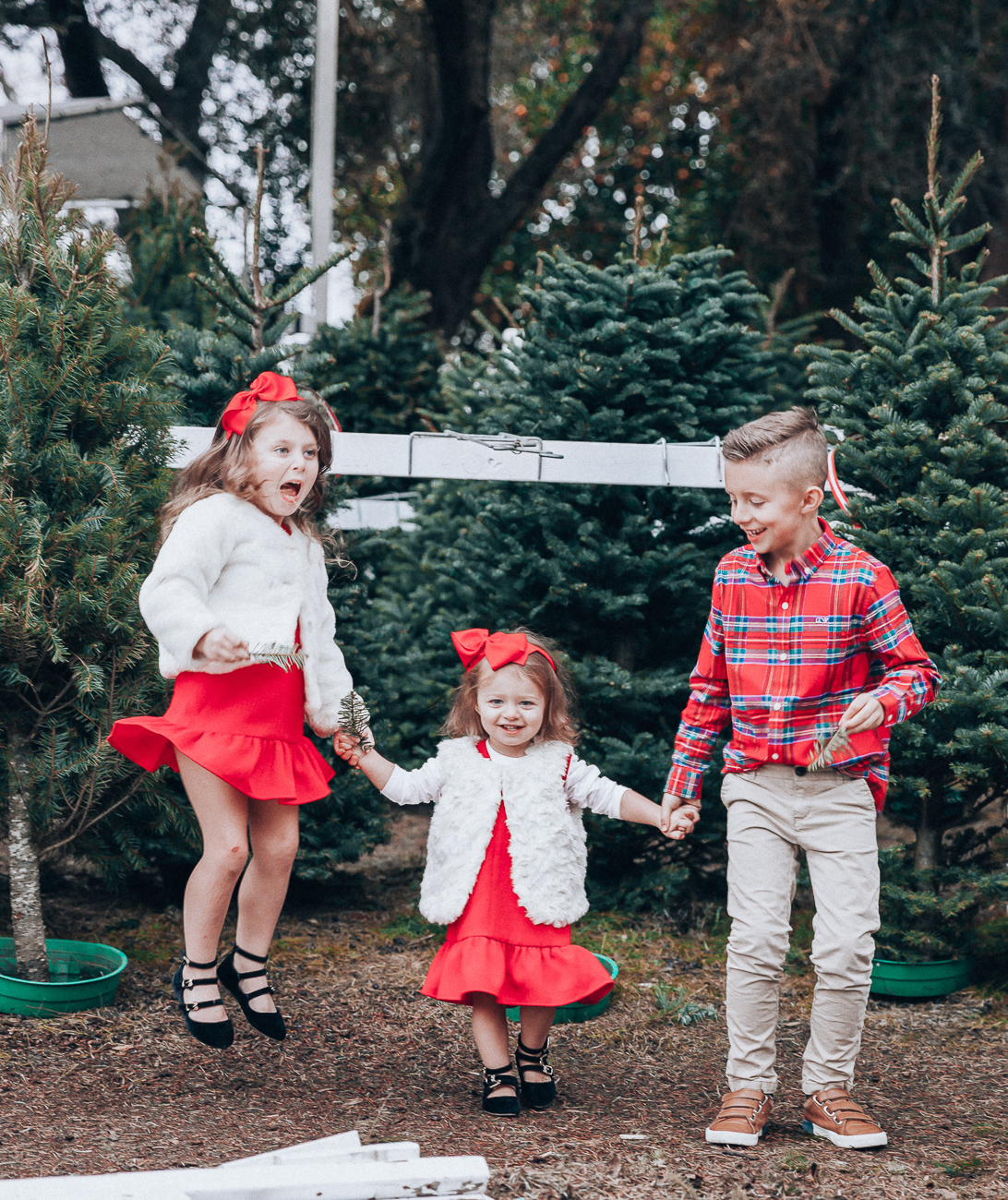 Cute Family Christmas Outfits featured by top San Francisco fashion blog, The Girl in the Yellow Dress: image of a woman wearing a Vineyard Vines paid dress, Cecelia booties, Vineyard Vines tassel earrings; a man wearing Vineyard Vines plaid shirt, sweater and slim fit pants, Cole Haan sneakers; a little boy wearing a Vineyard Vines plaid shirt and corduroy pants; a little girl wearing a Vineyard Vines party dress, GAP faux fur jacket, and Old Navy buckle flats