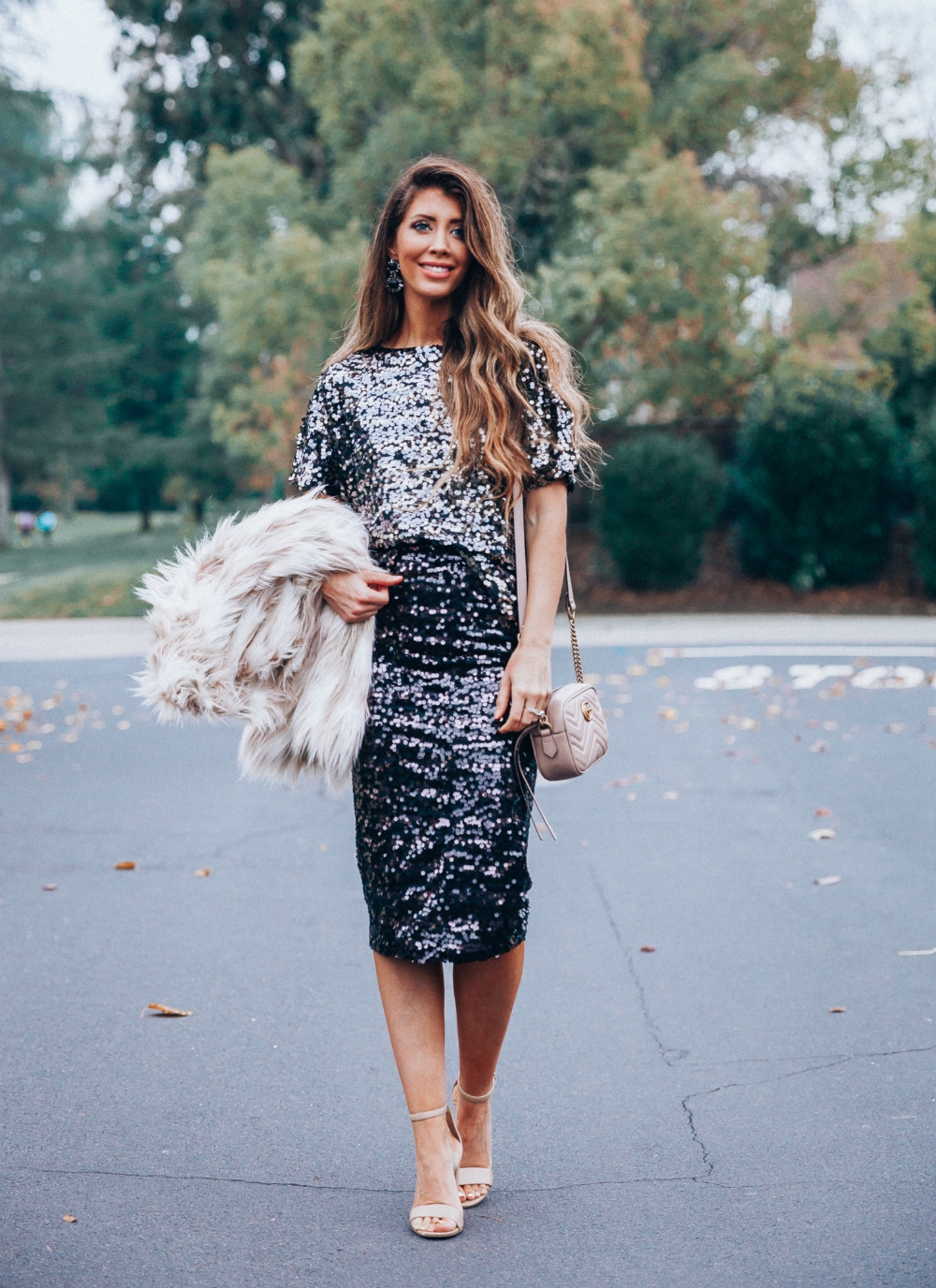 Cute NYE look featured by top San Francisco fashion blog, The Girl in the Yellow Dress: image of a woman wearing an H&M sequin skirt, H&M sequin top, Stella coat, Sam Edelman strap sandals, Gucci leather camera bag, Baublebar drop statement earrings