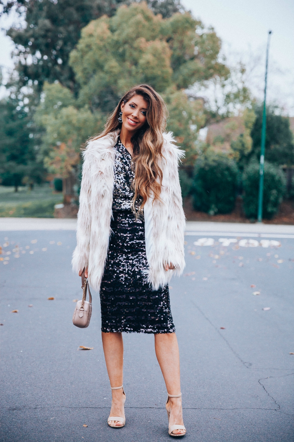 Cute NYE look featured by top San Francisco fashion blog, The Girl in the Yellow Dress: image of a woman wearing an H&M sequin skirt, H&M sequin top, Stella coat, Sam Edelman strap sandals, Gucci leather camera bag, Baublebar drop statement earrings