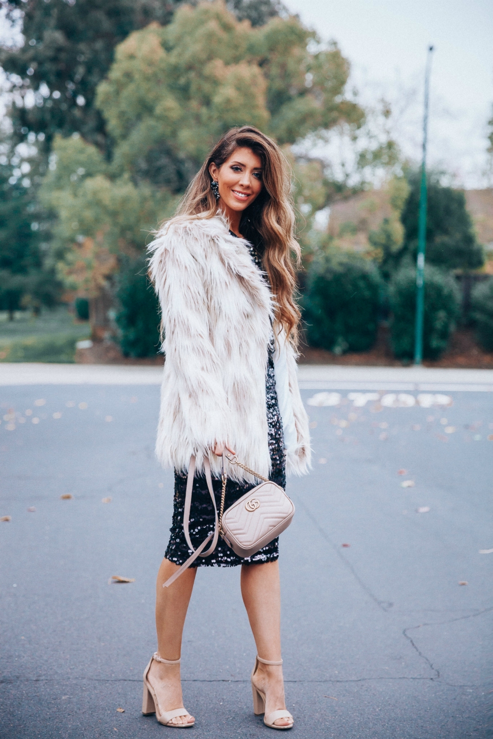 Cute NYE look featured by top San Francisco fashion blog, The Girl in the Yellow Dress: image of a woman wearing an H&M sequin skirt, H&M sequin top, Stella coat, Sam Edelman strap sandals, Gucci leather camera bag, Baublebar drop statement earrings