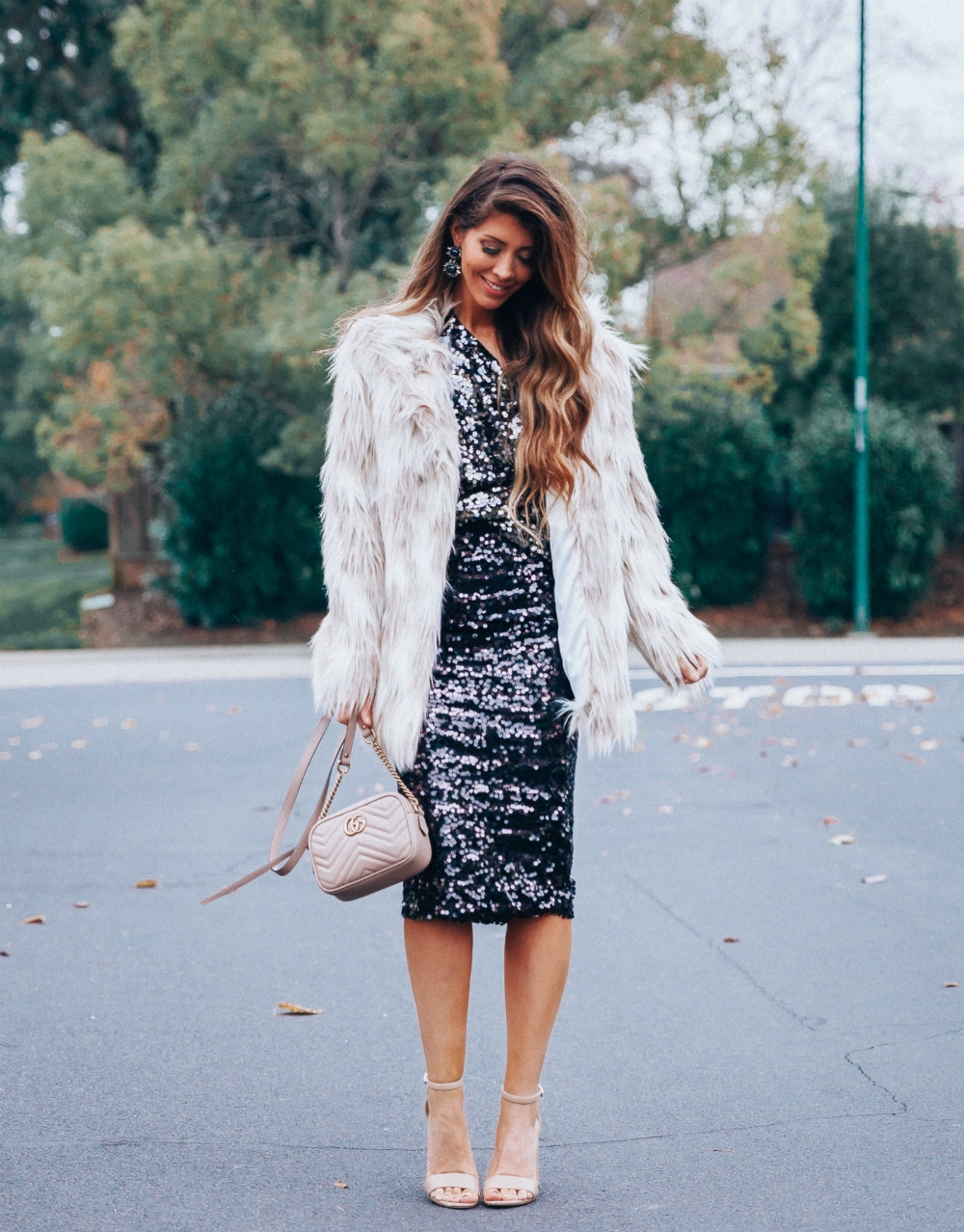 Cute NYE look featured by top San Francisco fashion blog, The Girl in the Yellow Dress: image of a woman wearing an H&M sequin skirt, H&M sequin top, Stella coat, Sam Edelman strap sandals, Gucci leather camera bag, Baublebar drop statement earrings