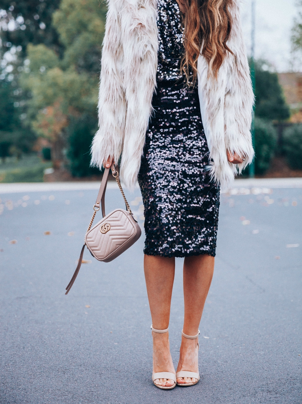 Cute NYE look featured by top San Francisco fashion blog, The Girl in the Yellow Dress: image of a woman wearing an H&M sequin skirt, H&M sequin top, Stella coat, Sam Edelman strap sandals, Gucci leather camera bag, Baublebar drop statement earrings