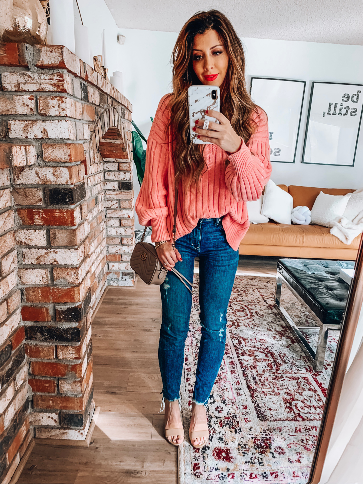 Valentine's Day Outfits featured by top US fashion blog The Girl in the Yellow Dress; Image of a woman wearing Revolve pink sweater, Revolve jeans and Sam Edelman heels.