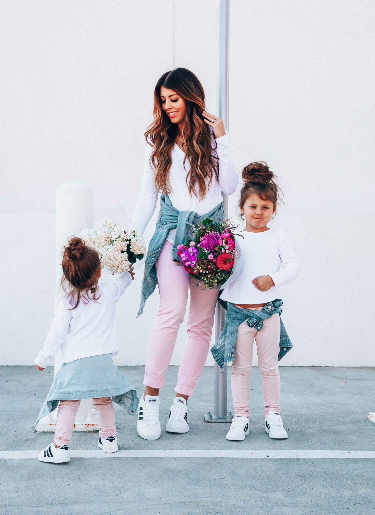 Spring Adidas featured by top US fashion blog The Girl in the Yellow Dress; Image of a woman and her daughters wearing pink pants and Adidas.