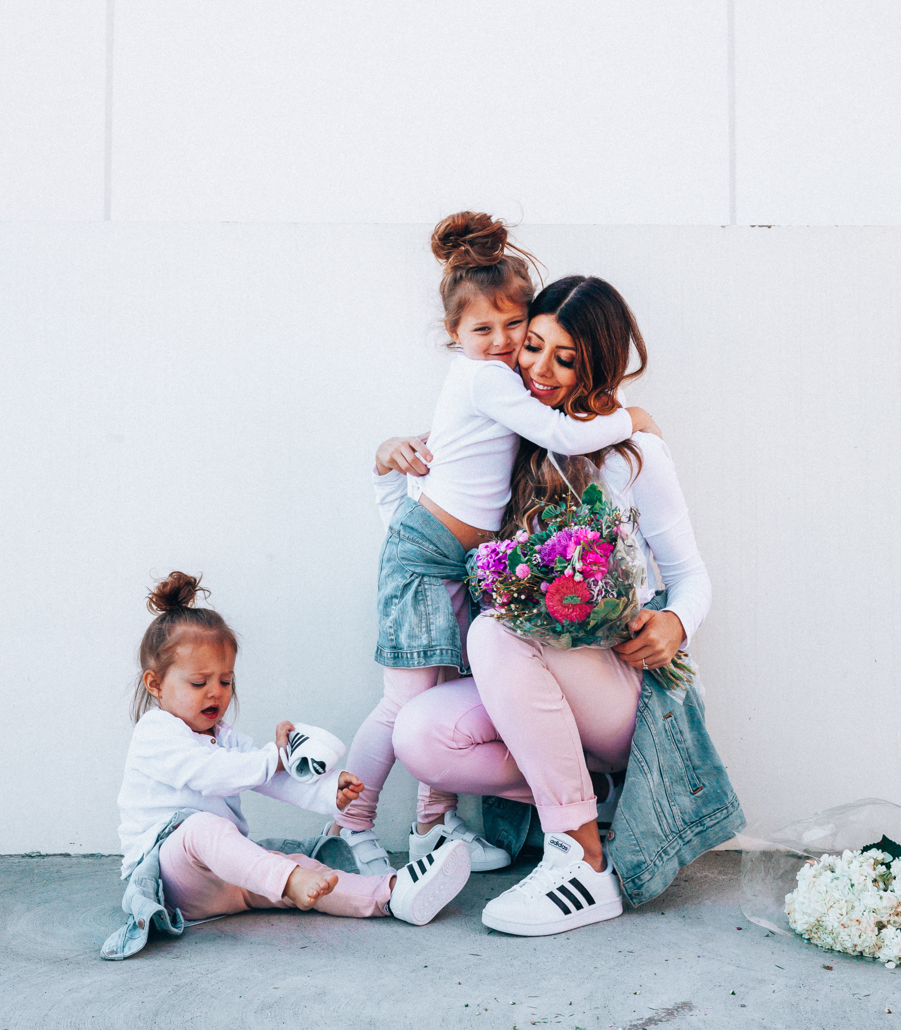 Spring Adidas featured by top US fashion blog The Girl in the Yellow Dress; Image of a woman and her daughters wearing pink pants and Adidas.