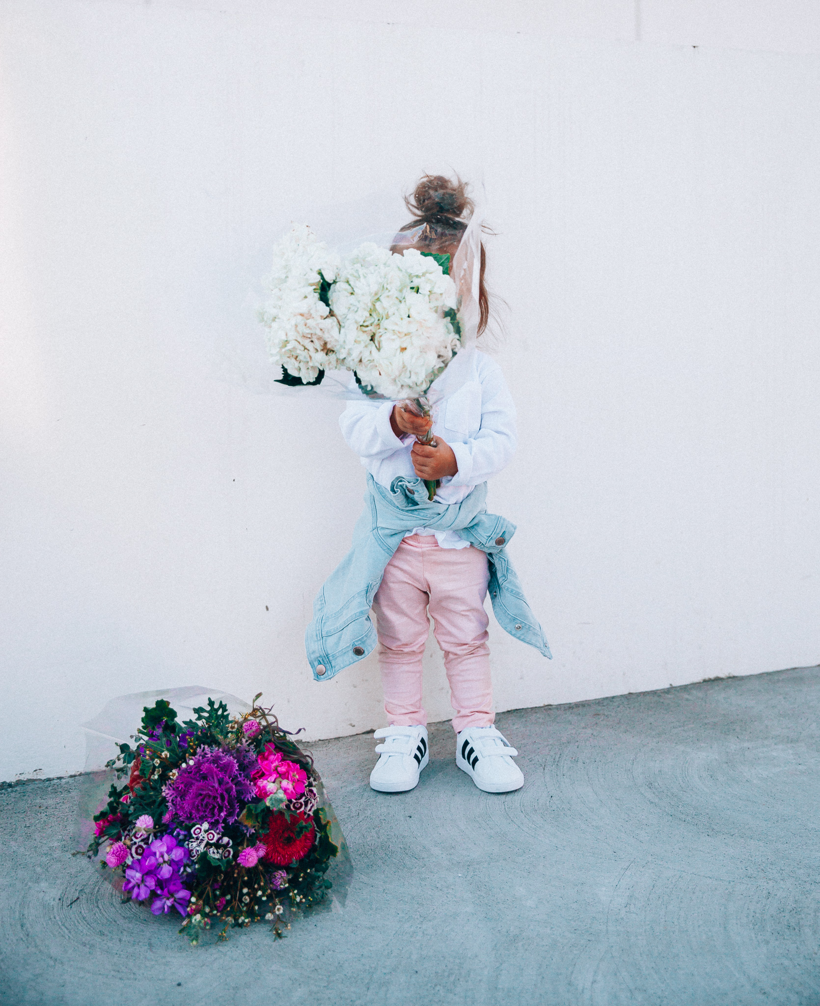 Spring Adidas featured by top US fashion blog The Girl in the Yellow Dress; Image of a woman and her daughters wearing pink pants and Adidas.