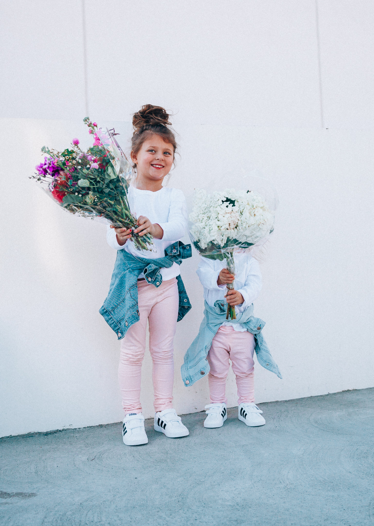 Spring Adidas featured by top US fashion blog The Girl in the Yellow Dress; Image of a woman and her daughters wearing pink pants and Adidas.