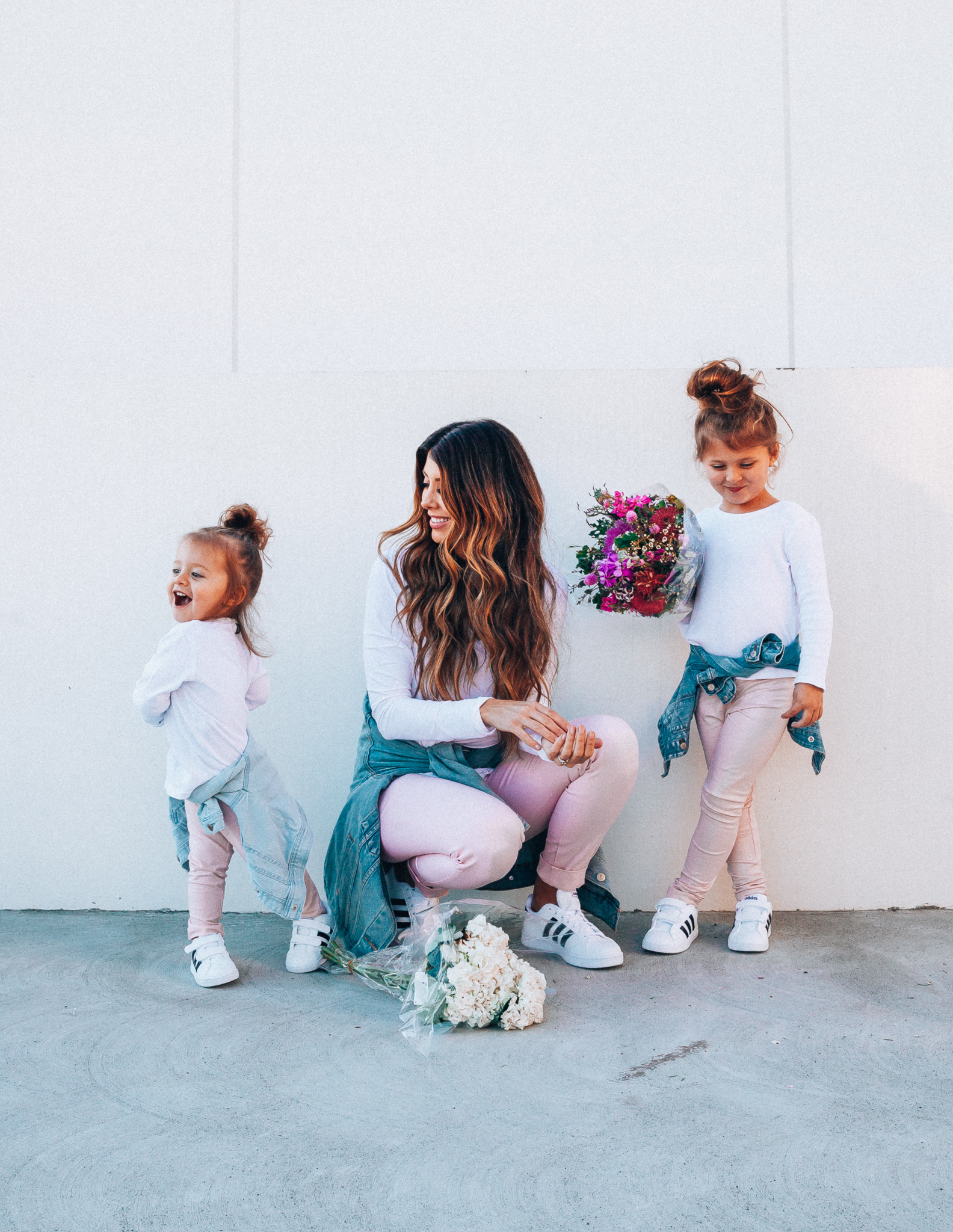 Spring Adidas featured by top US fashion blog The Girl in the Yellow Dress; Image of a woman and her daughters wearing pink pants and Adidas.