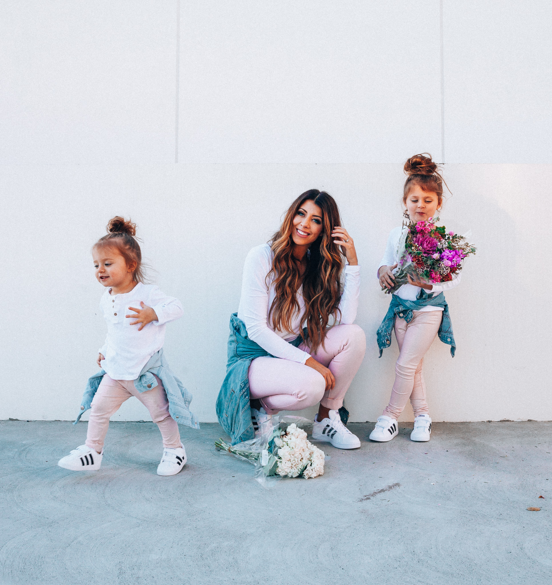 Spring Adidas featured by top US fashion blog The Girl in the Yellow Dress; Image of a woman and her daughters wearing pink pants and Adidas.