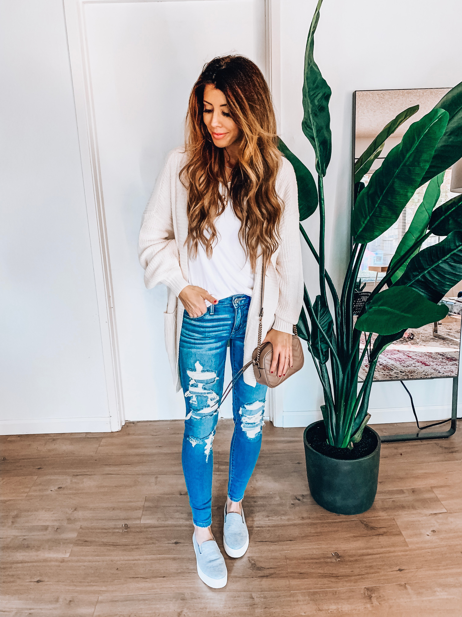 Spring Jeans featured by top US fashion blog The Girl in the Yellow Dress; Image of a woman wearing a cardigan from Style Me, BP white tee, Halogen sneakers, American Eagle jeans and Gucci bag.