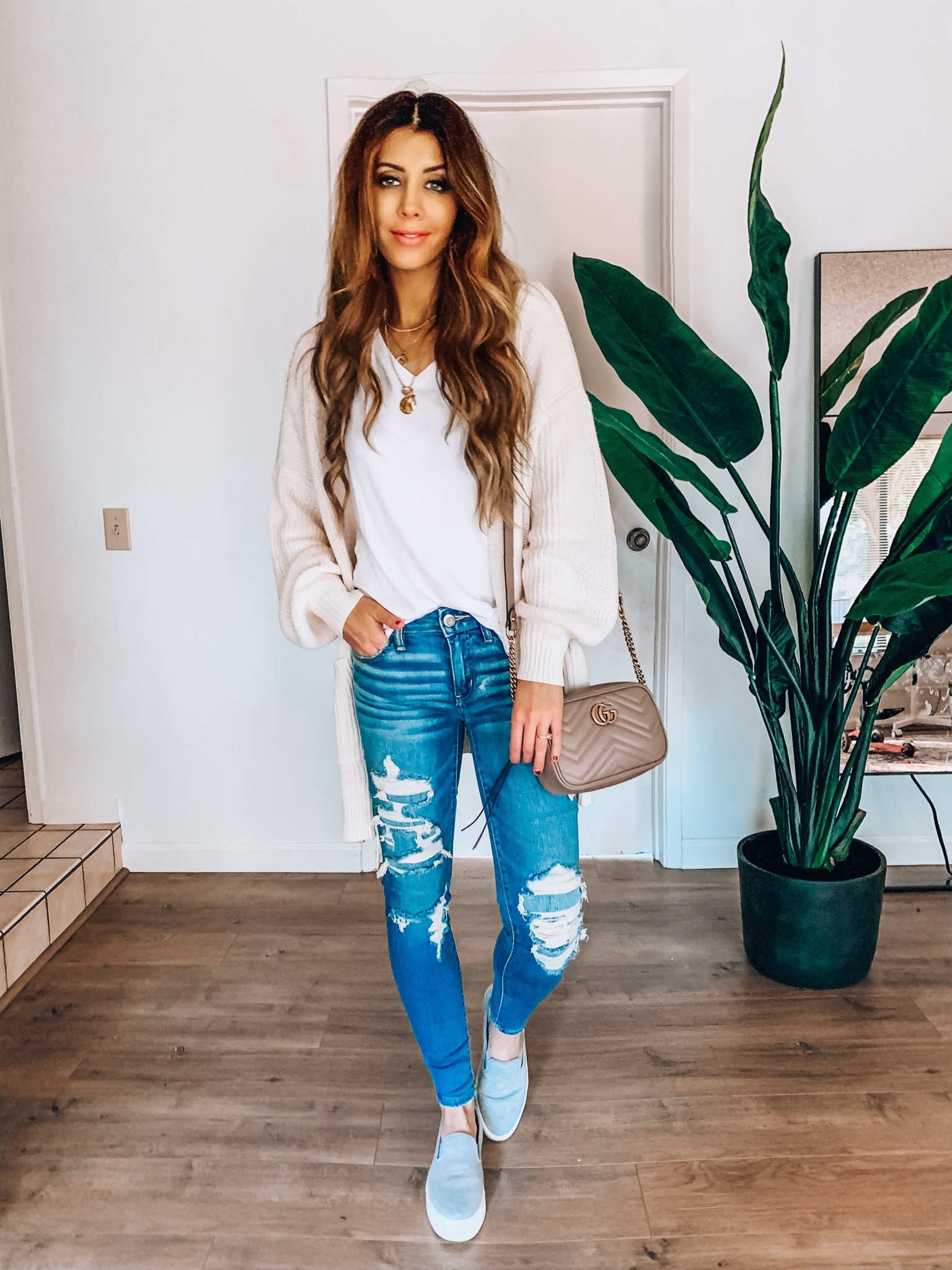 Spring Jeans featured by top US fashion blog The Girl in the Yellow Dress; Image of a woman wearing a cardigan from Style Me, BP white tee, Halogen sneakers, American Eagle jeans and Gucci bag.