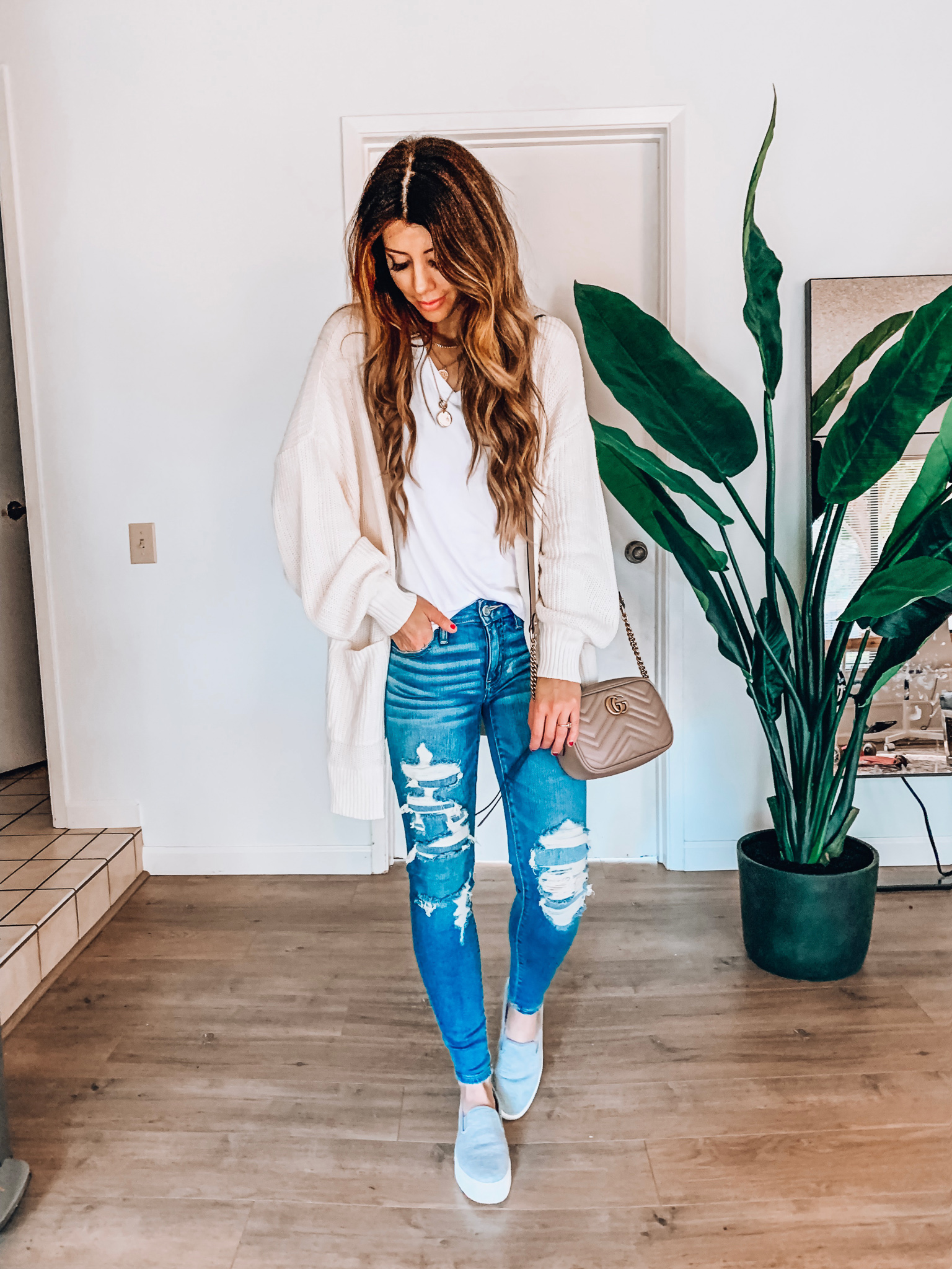 Spring Jeans featured by top US fashion blog The Girl in the Yellow Dress; Image of a woman wearing a cardigan from Style Me, BP white tee, Halogen sneakers, American Eagle jeans and Gucci bag.