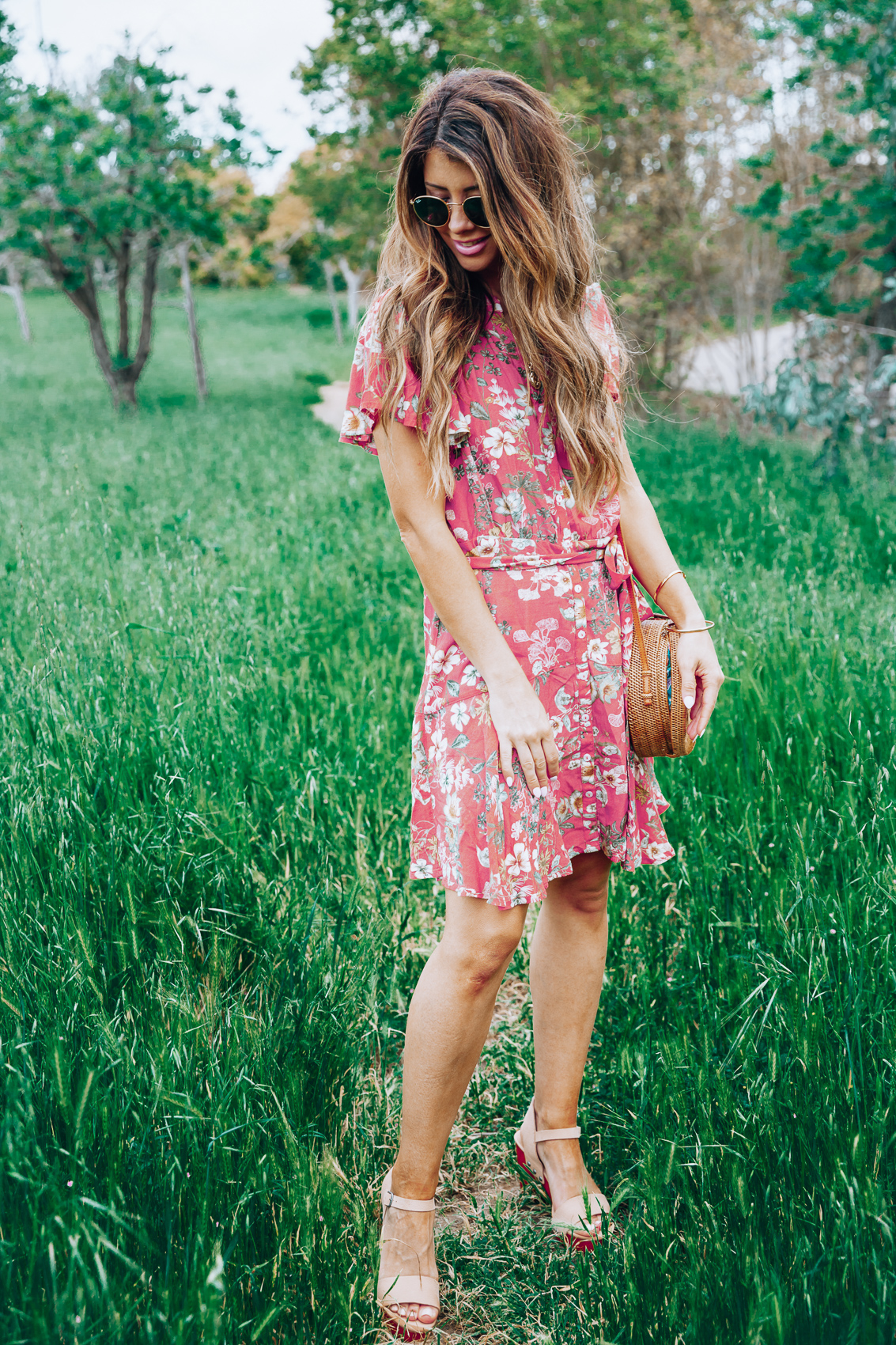Cute Summer Dresses featured by top US fashion blog The Girl in the Yellow Dress; Image of a woman wearing red floral dress.