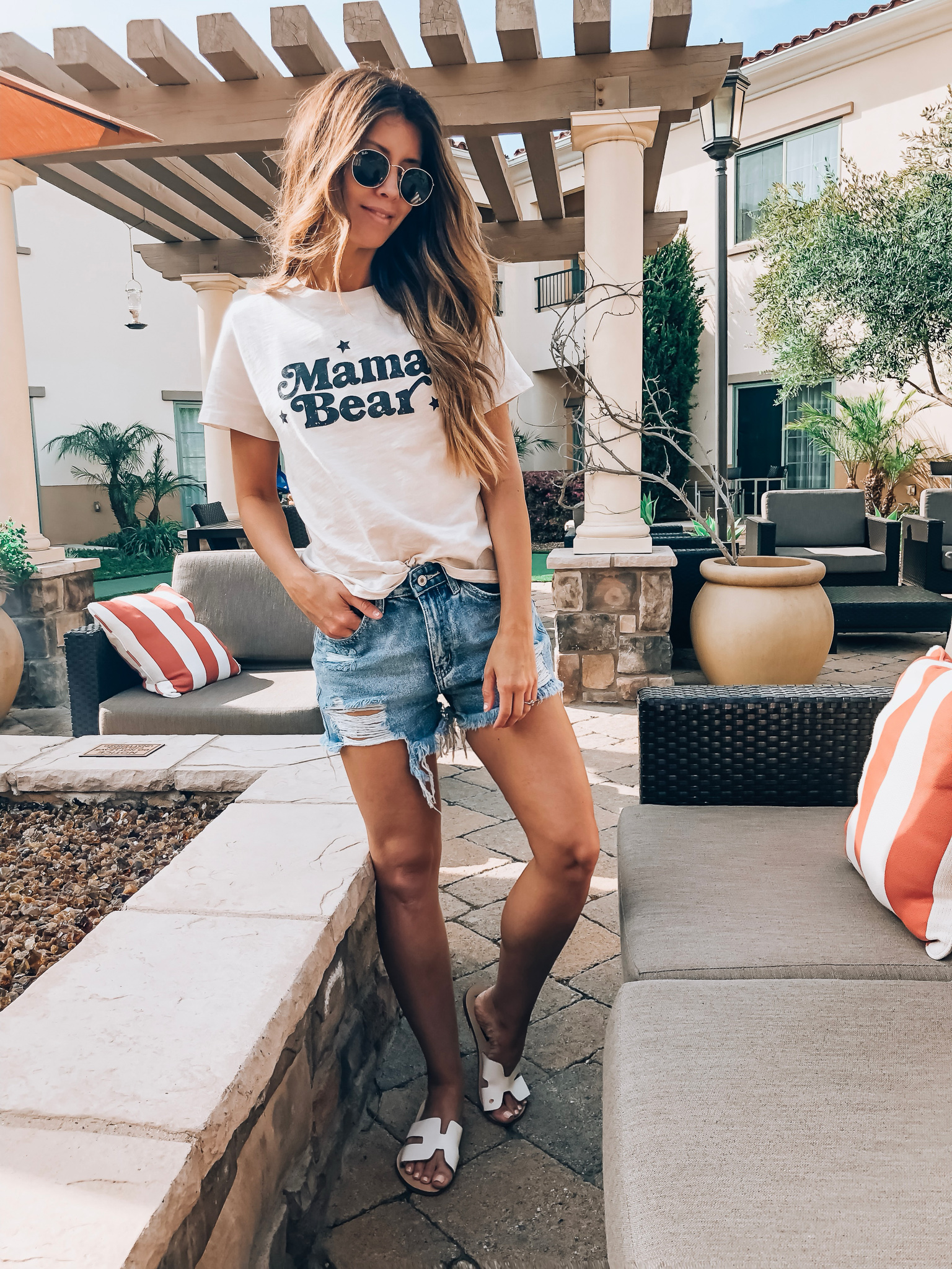 Santa Barbara Packing List featured by top US fashion blog The Girl in the Yellow Dress; Image of a woman wearing graphic tee and denim shorts.