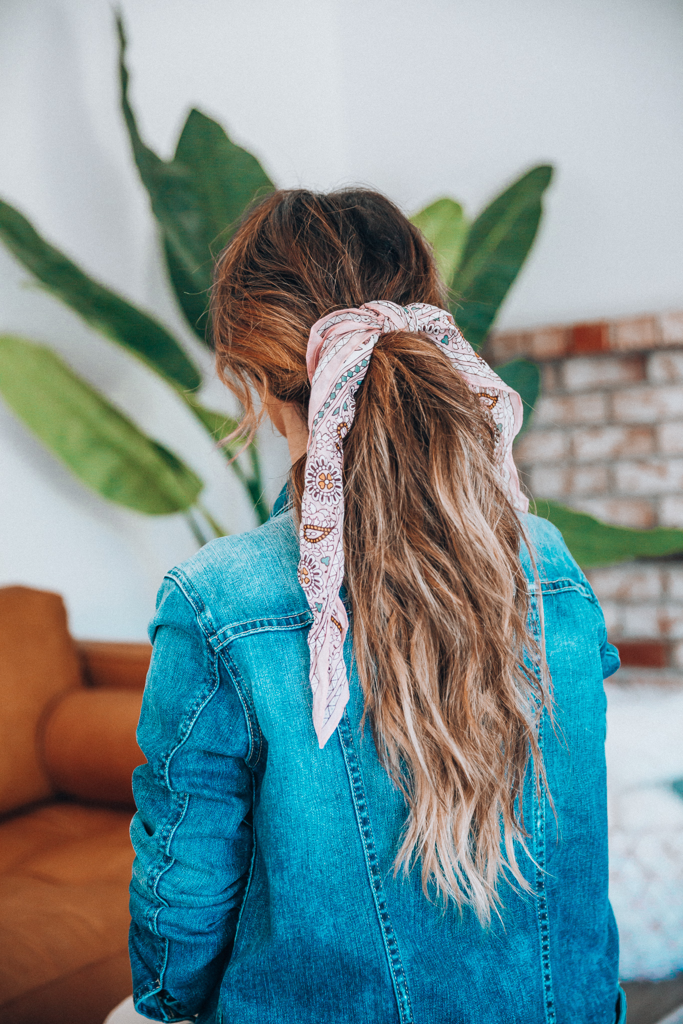 Hair Accessories for Long Hair featured by top US fashion blog The Girl in the Yellow Dress; Image of a woman wearing a denim jacket.