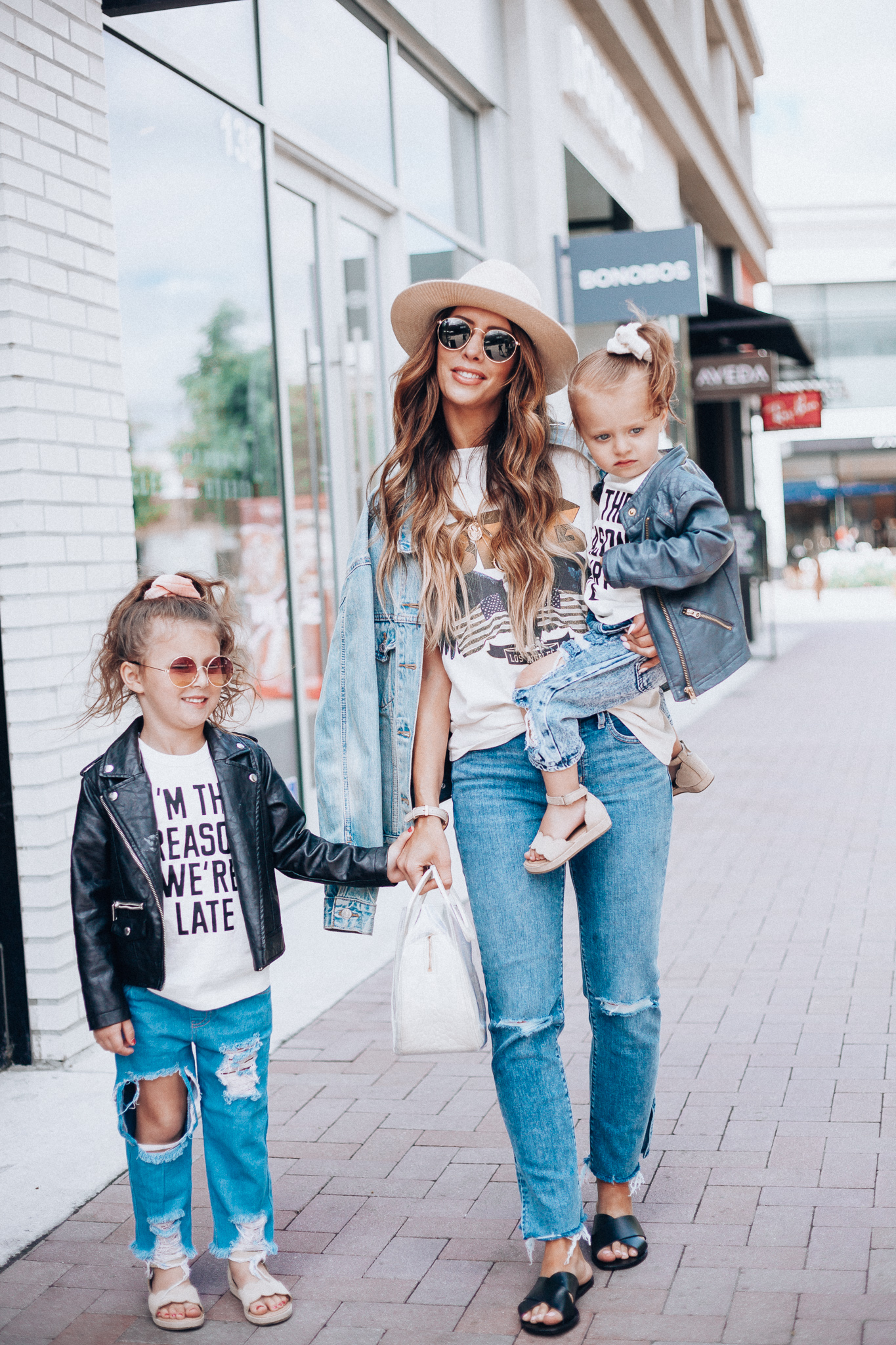 Cute Graphic Tees featured by top US fashion blog The Girl in the Yellow Dress; Image of a woman wearing a graphic tee and jeans.