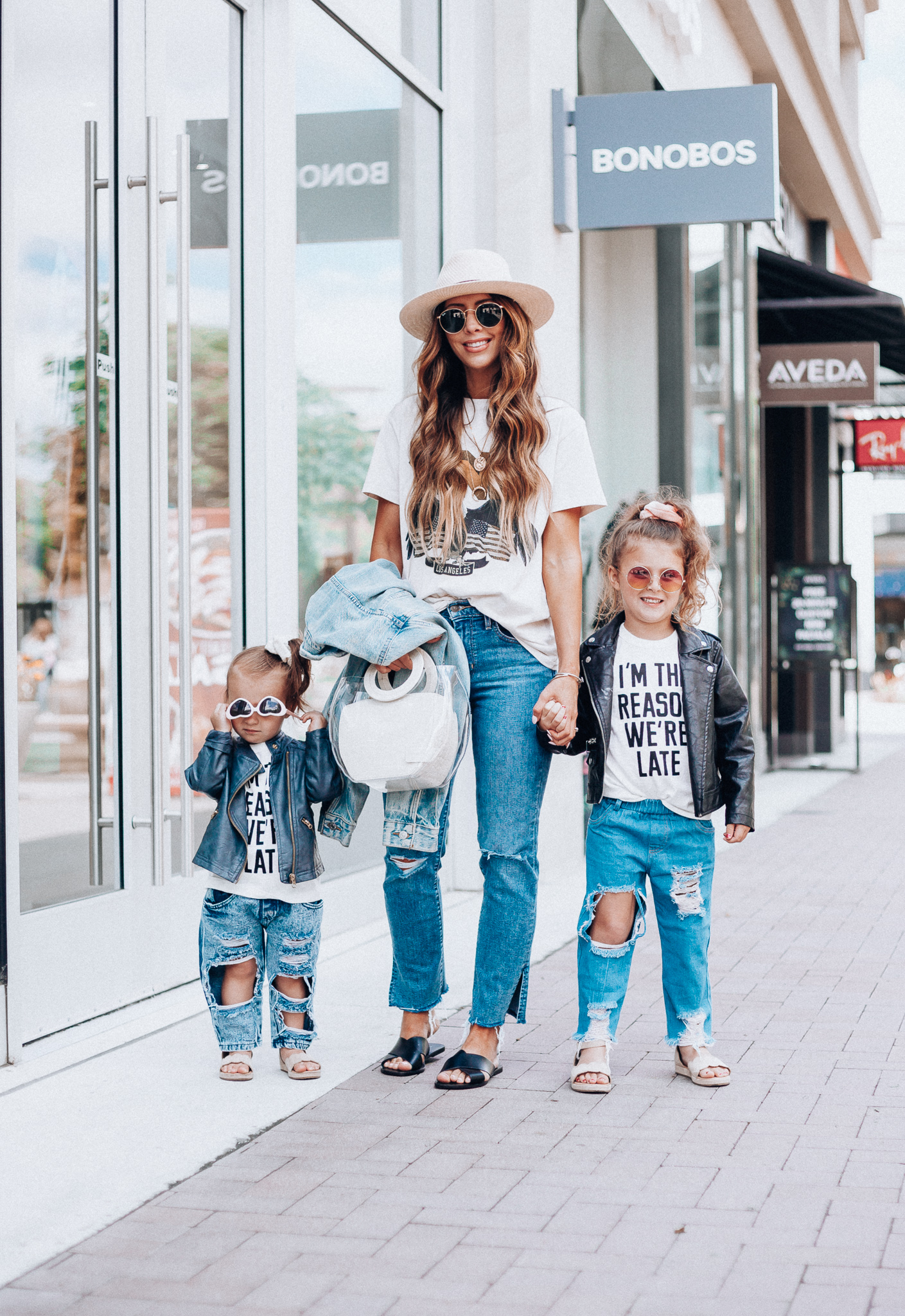 Cute Graphic Tees featured by top US fashion blog The Girl in the Yellow Dress; Image of a woman wearing a graphic tee and jeans.