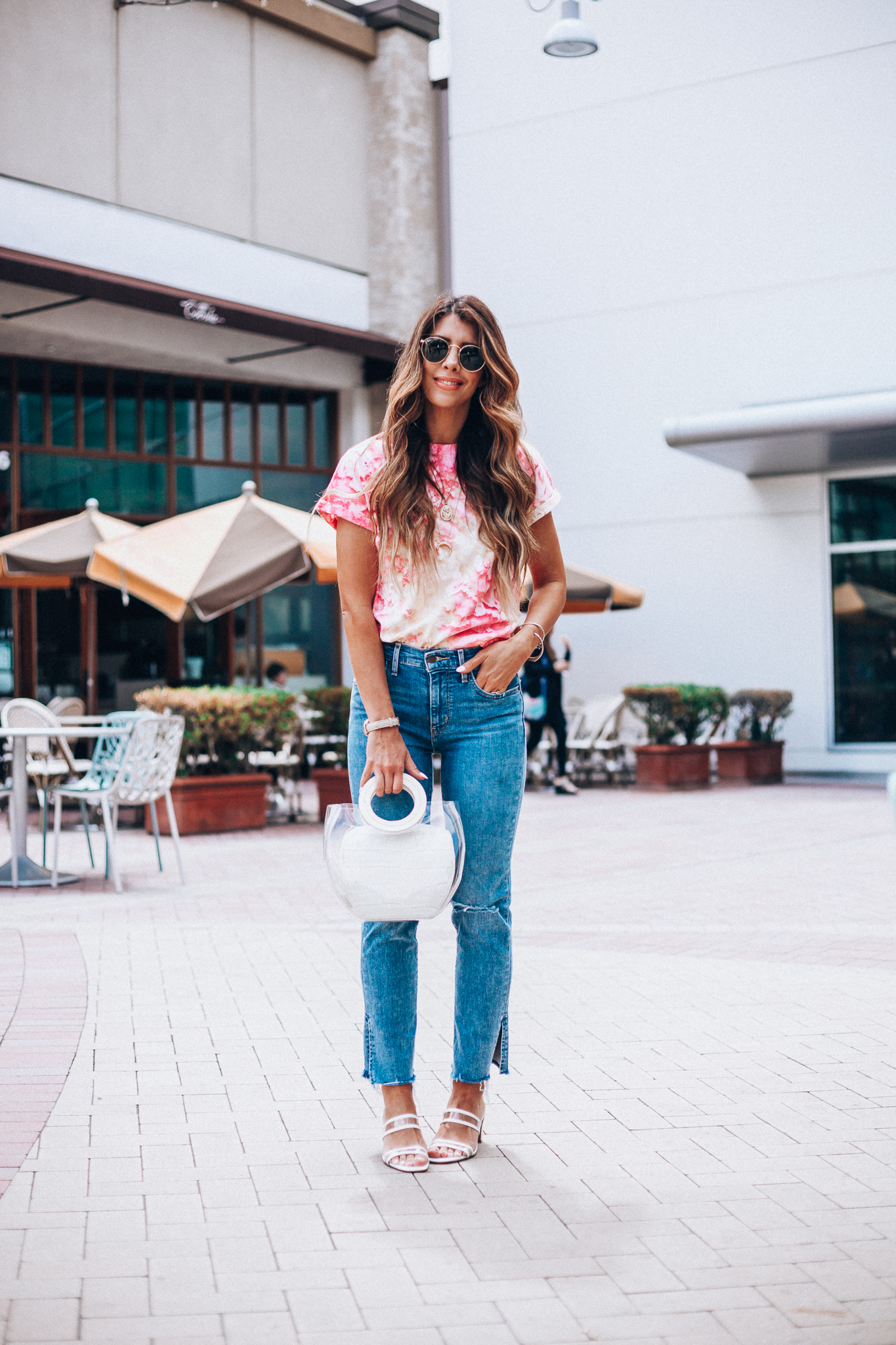 Summer Trends featured by top US fashion blog The Girl in the Yellow Dress; Image of a woman wearing Nordstrom shirt, Levi's, Staud bag, Steven sandals and Ray-Ban sunglasses.