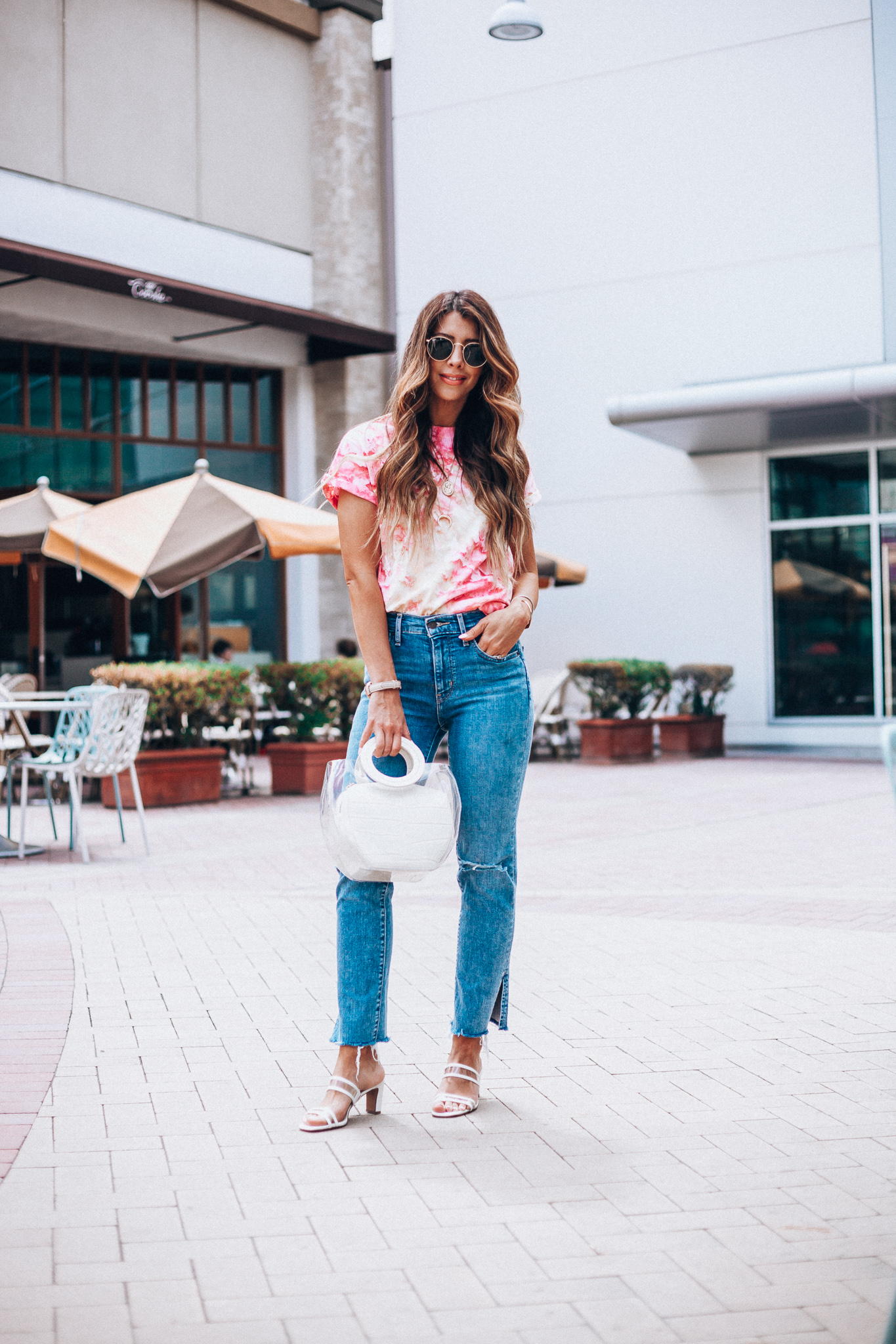 Summer Trends featured by top US fashion blog The Girl in the Yellow Dress; Image of a woman wearing Nordstrom shirt, Levi's, Staud bag, Steven sandals and Ray-Ban sunglasses.