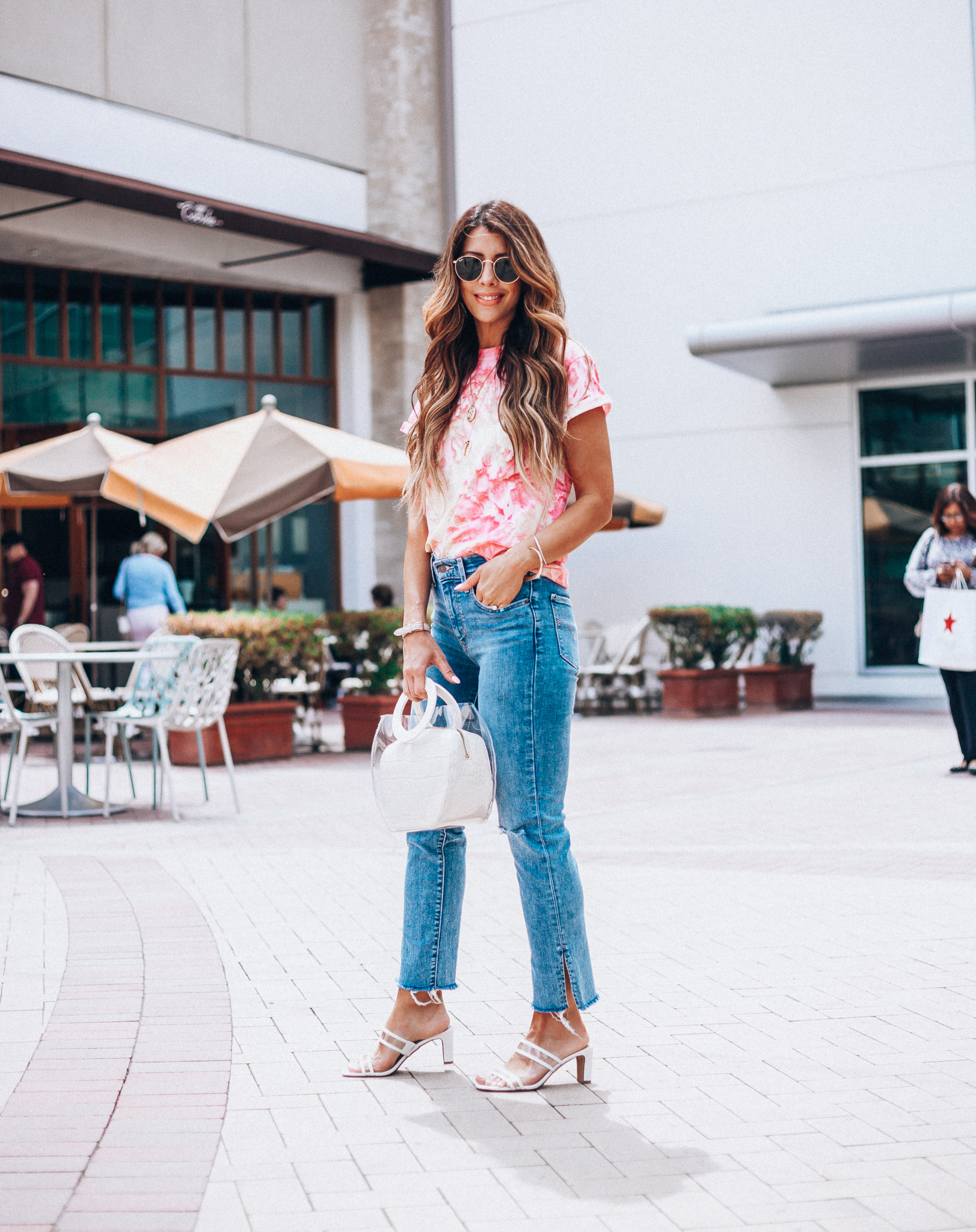 Summer Trends featured by top US fashion blog The Girl in the Yellow Dress; Image of a woman wearing Nordstrom shirt, Levi's, Staud bag, Steven sandals and Ray-Ban sunglasses.