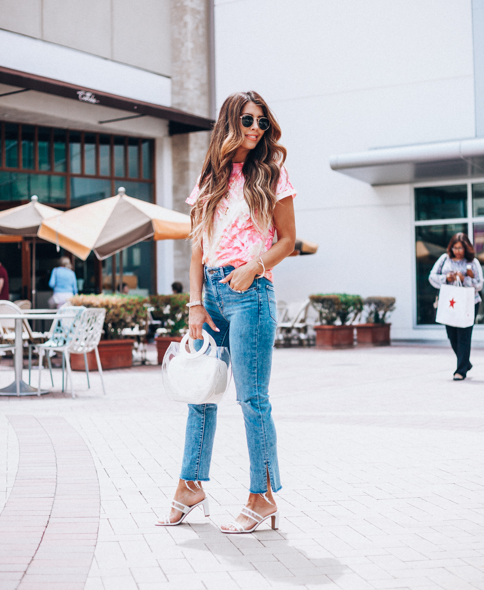 Summer Trends featured by top US fashion blog The Girl in the Yellow Dress; Image of a woman wearing Nordstrom shirt, Levi's, Staud bag, Steven sandals and Ray-Ban sunglasses.