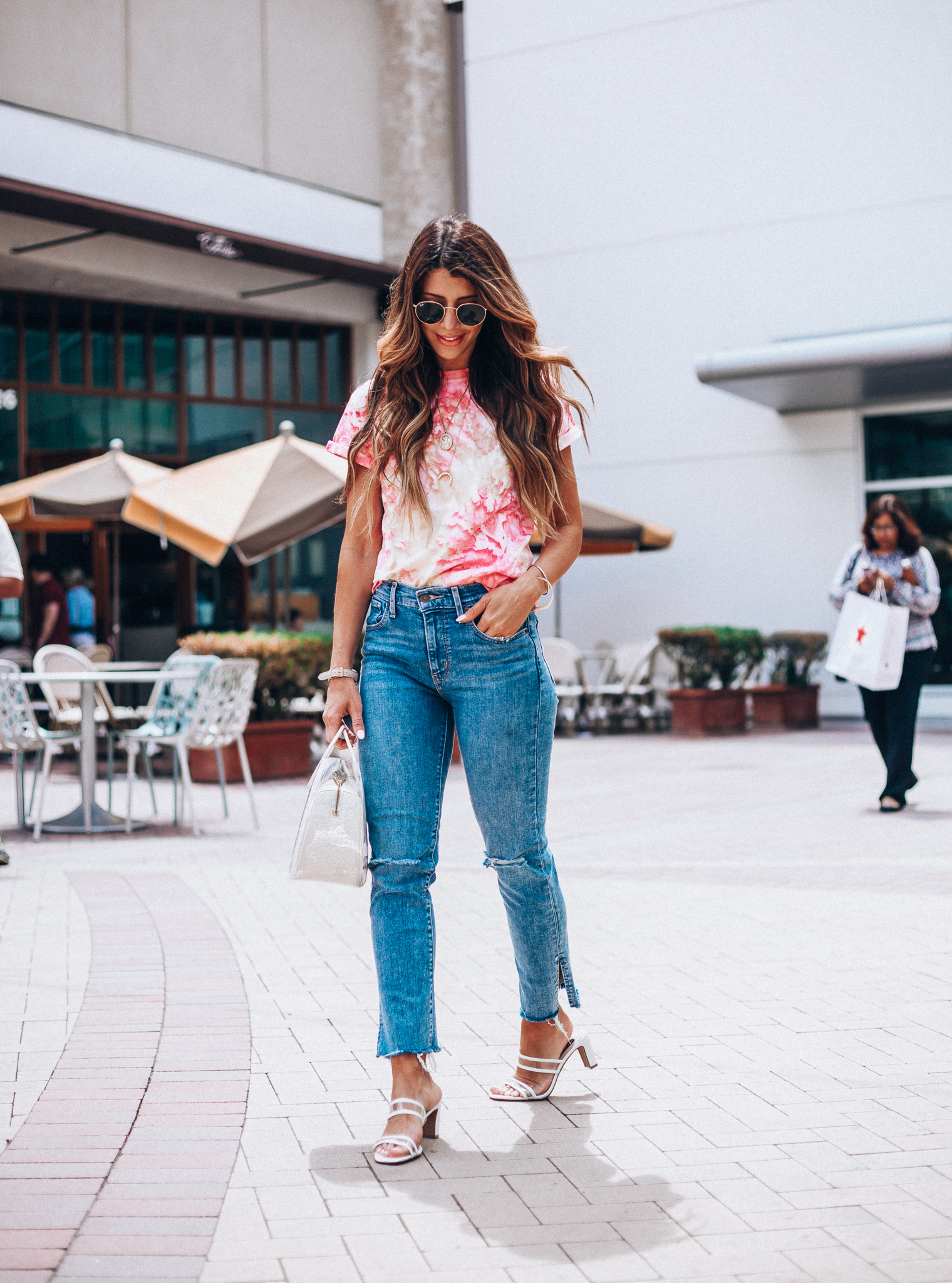 Summer Trends featured by top US fashion blog The Girl in the Yellow Dress; Image of a woman wearing Nordstrom shirt, Levi's, Staud bag, Steven sandals and Ray-Ban sunglasses.