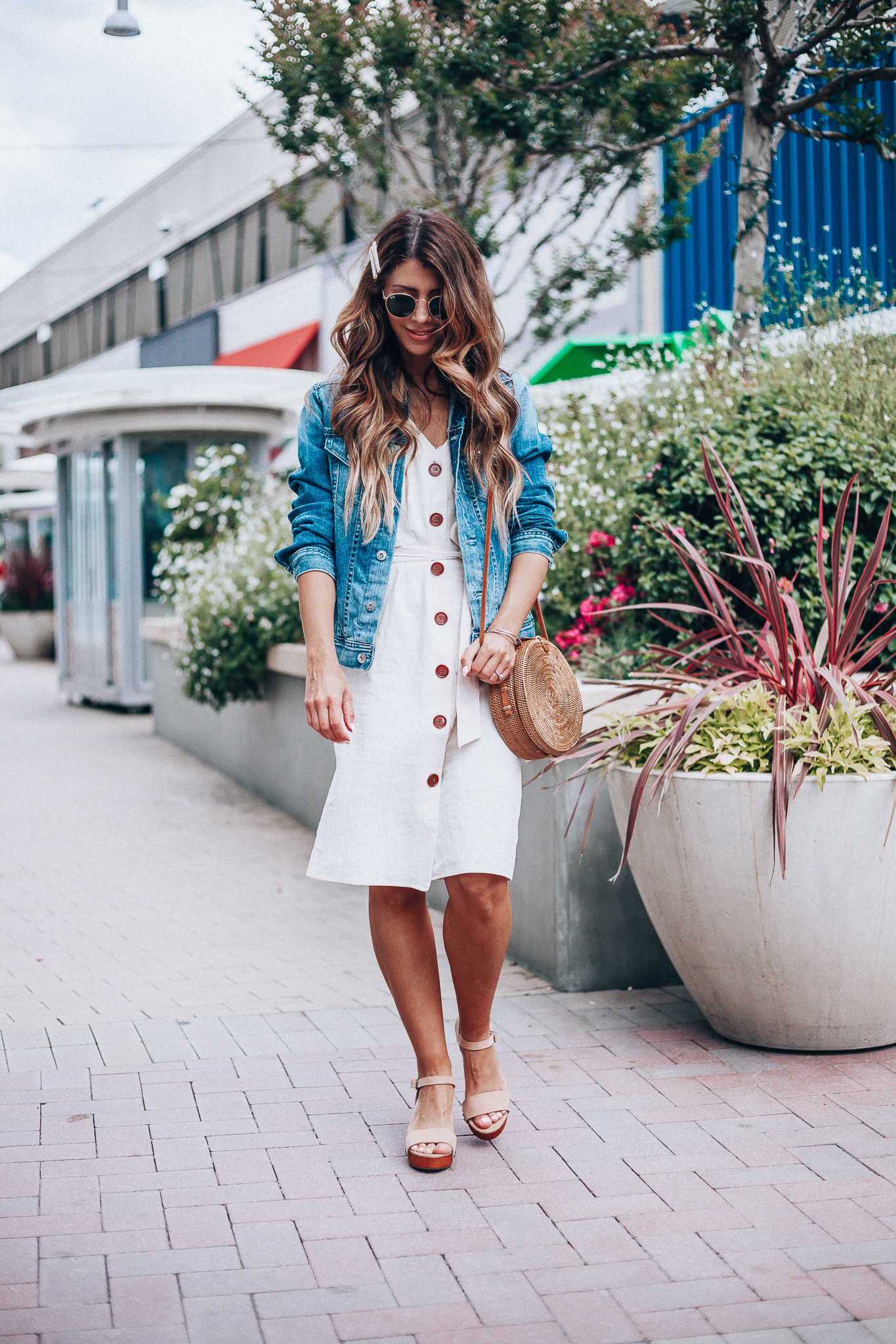 Cute Summer Dresses featured by top US fashion blog The Girl in the Yellow Dress; Image of a woman wearing Evereve denim jacket, Nordstrom button down dress and Evereve wedges.