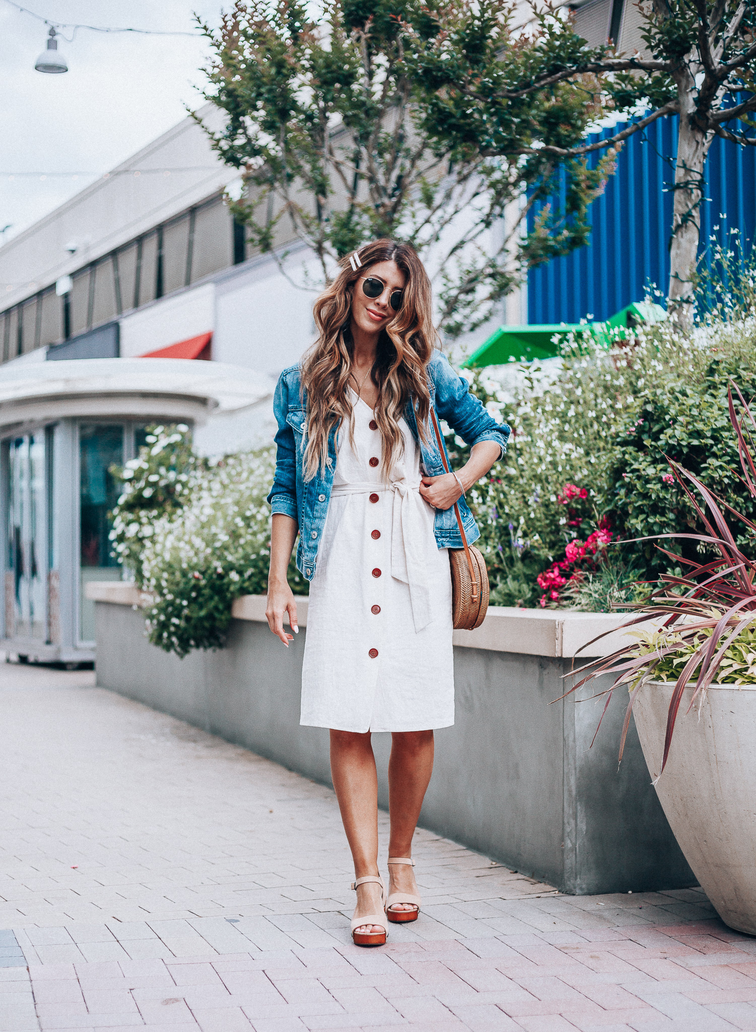 Cute Summer Dresses featured by top US fashion blog The Girl in the Yellow Dress; Image of a woman wearing Evereve denim jacket, Nordstrom button down dress and Evereve wedges.