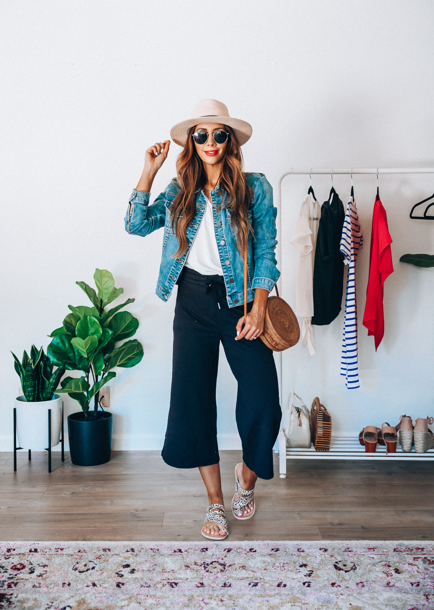 Summer Try On: Evereve Favorites by popular San Francisco fashion blog, The Girl in the Yellow Dress: image of a woman wearing a Evereve Wilt Slouchy Boyfriend Tee, Evereve Kut From The Kloth Amelia Denim Jacket, Evereve  Z Supply Wide Leg Crop Pant, Dolce Vita Nelly Leopard Slide, Nordstrom Ray-Ban Icons 53mm Retro Sunglasses, Nordstrom Panama Hat by SOLE SOCIETY, and holding a Bali Harvest Handwoven Round Woven Ata Rattan Bag.  