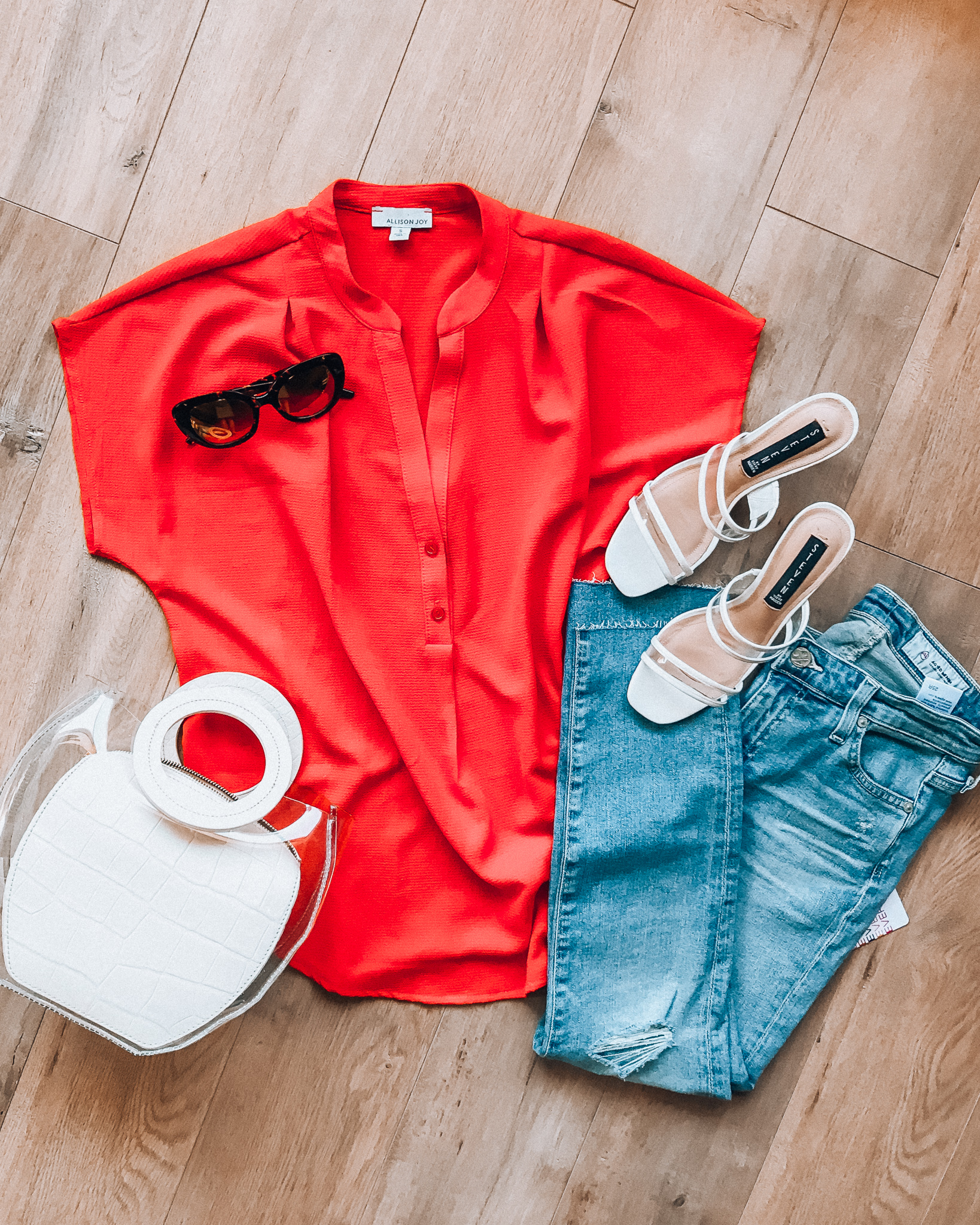 Casual Summer Outfit Ideas by popular San Francisco fashion blog, The Girl in the Yellow Dress: flat lay image of red Evereve Allison Joy Amelia Popover Top, Evereve Ag Prima Crop jeans, neutral Shopbop Steven Joie Vinyl Slides, Shopbop STAUD Frida Bag, and Nordstrom Le Specs 'Bandwagon' 51mm Polarized Sunglasses. 