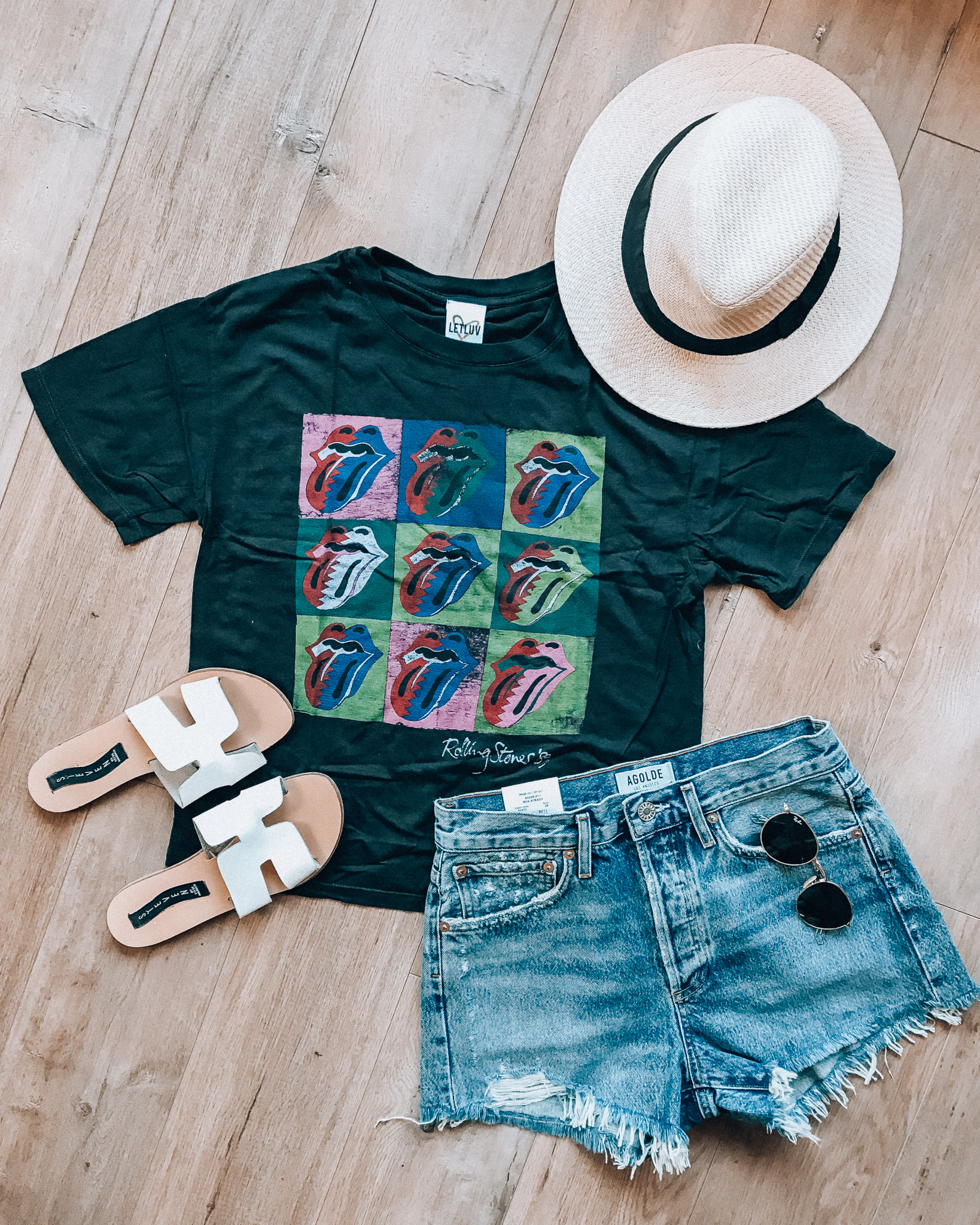 Casual Summer Outfit Ideas by popular San Francisco fashion blog, The Girl in the Yellow Dress: flat lay image of Evereve Letluv Rolling Stones Tee, Evereve Agolde Parker Short, Nordstrom Panama Hat by SOLE SOCIETY, Shopbop Steven Greece Slides, and Nordstrom Ray-Ban Icons 53mm Retro Sunglasses.  