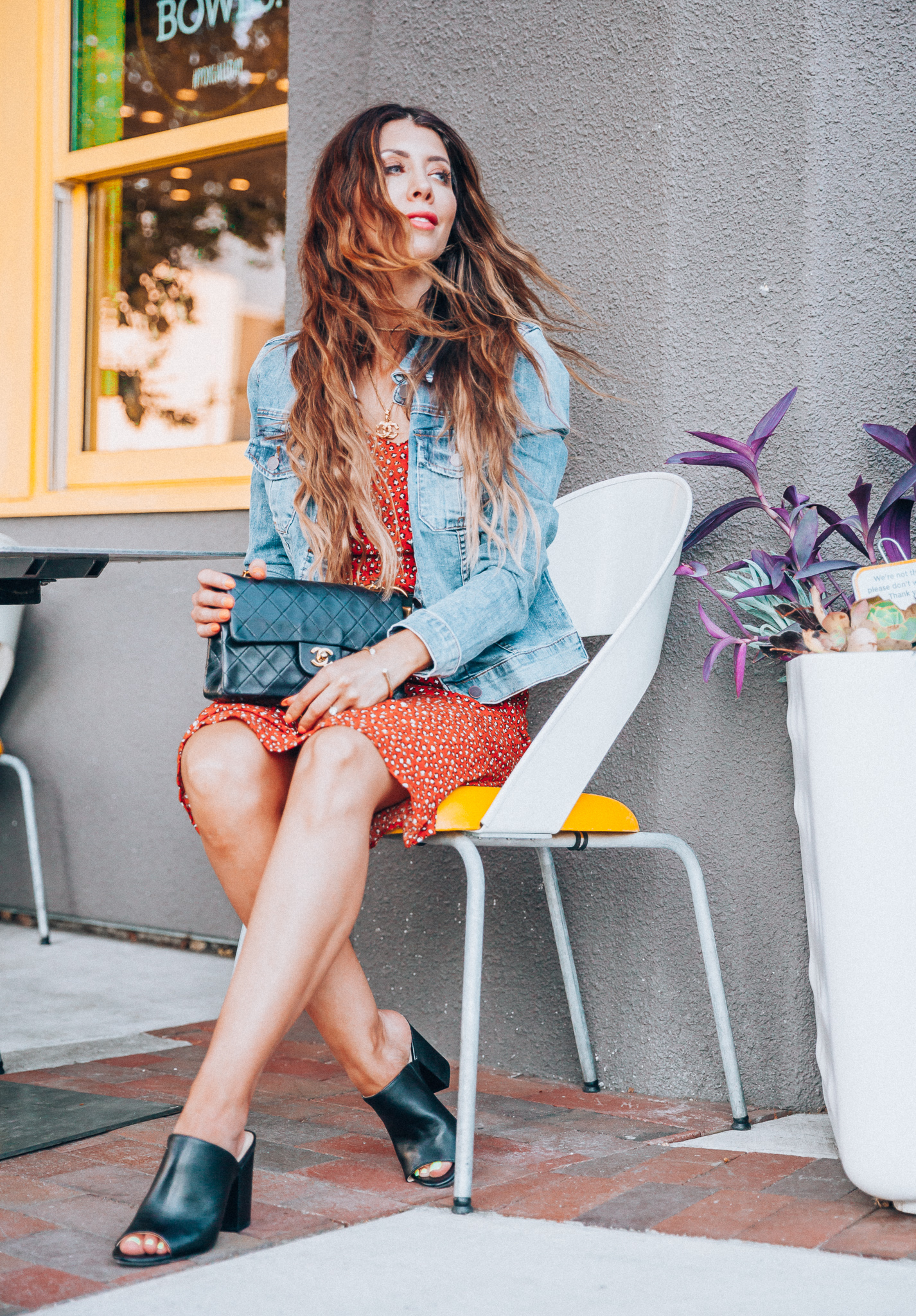 My Top Summer eBay Finds! by popular San Francisco life and style blog, The Girl in the Yellow Dress: image of a woman sitting outside and wearing a orange eBay leopard print dress, trucker Levis Strauss & Co denim Jacket, Women's Didi Block Heel Mules, Chanel Matelasse Double Flap Double Chain Bag, CHANEL CC Logo Pendant Necklace Gold Vintage 17.7inch, and Authentic Women Gucci Double GG Buckle Belt Size 85cm 1 inch width from eBay.