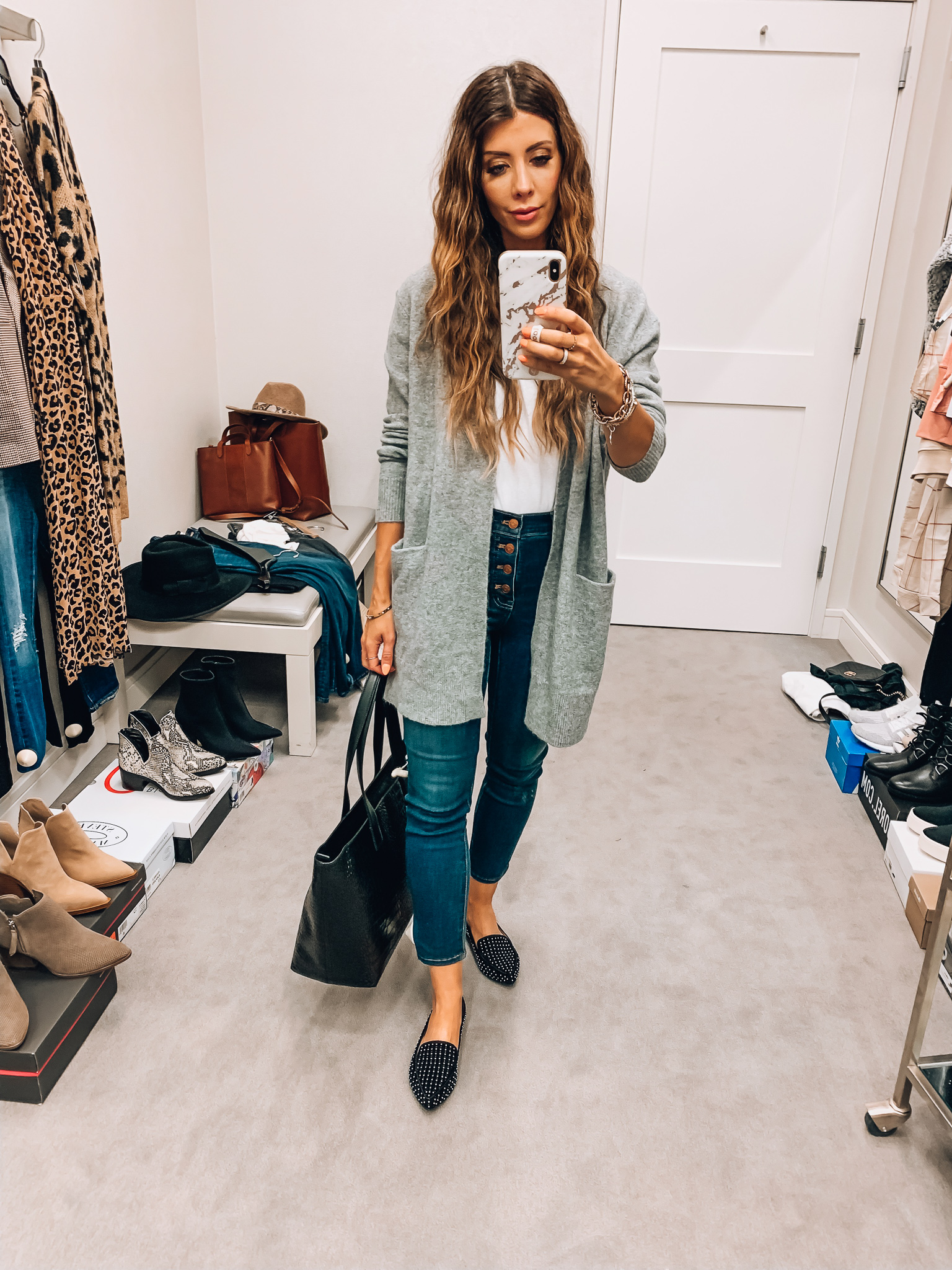 Nordstrom Anniversary Sale Early Access! by popular San Francisco fashion blog, The Girl in the Yellow Dress: image of a woman standing inside a Nordstrom dressing room wearing a BP. Longline Open Cardigan, Madewell 10-Inch High Waist Skinny Jeans: Button Front Edition, Blondo Eliza Waterproof Bootie, BP. V Neck Tee and Madewell Small Transport Leather Crossbody Tote